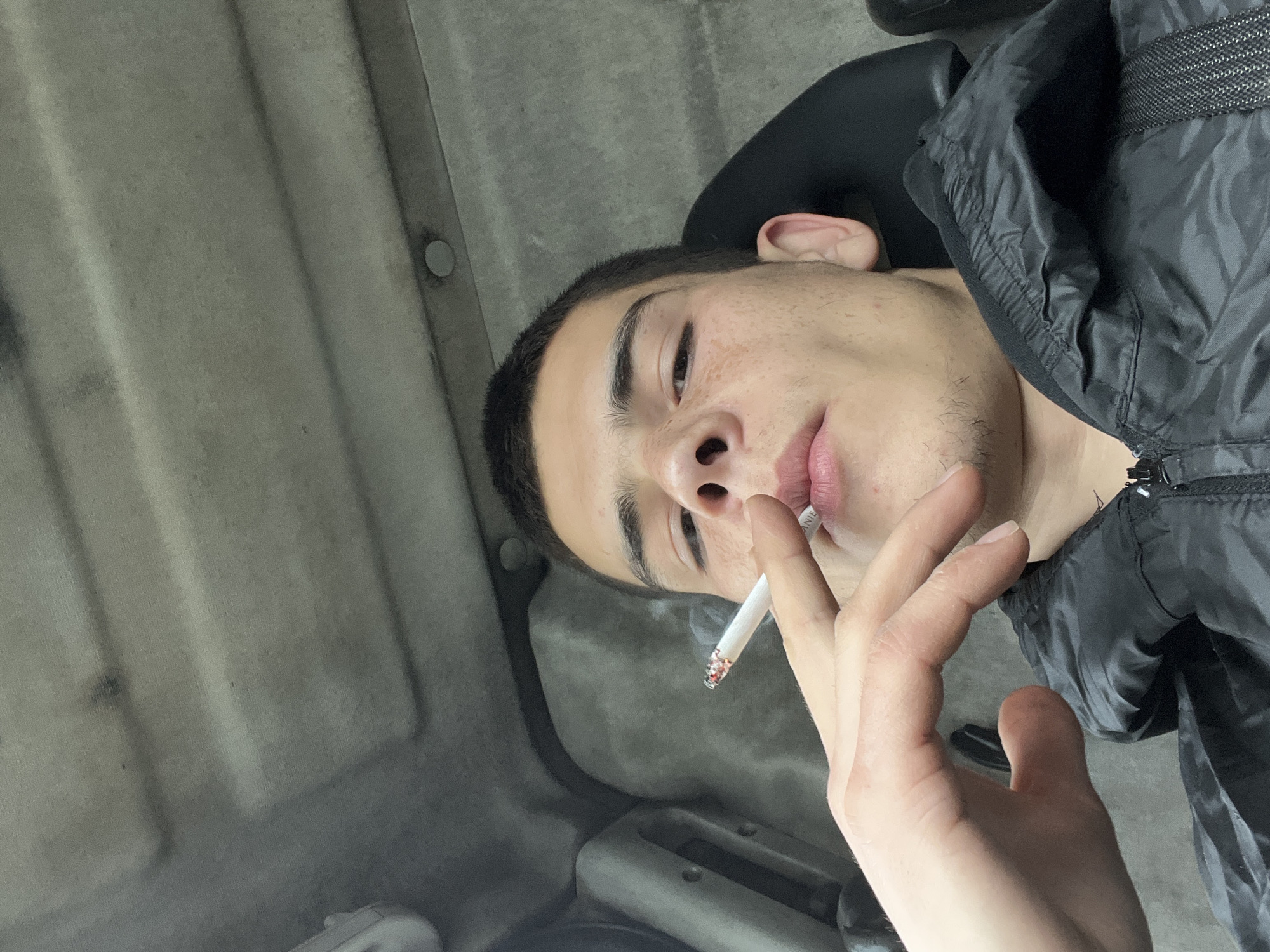 Young man photographed smoking cigarette in Sopot, Bulgaria