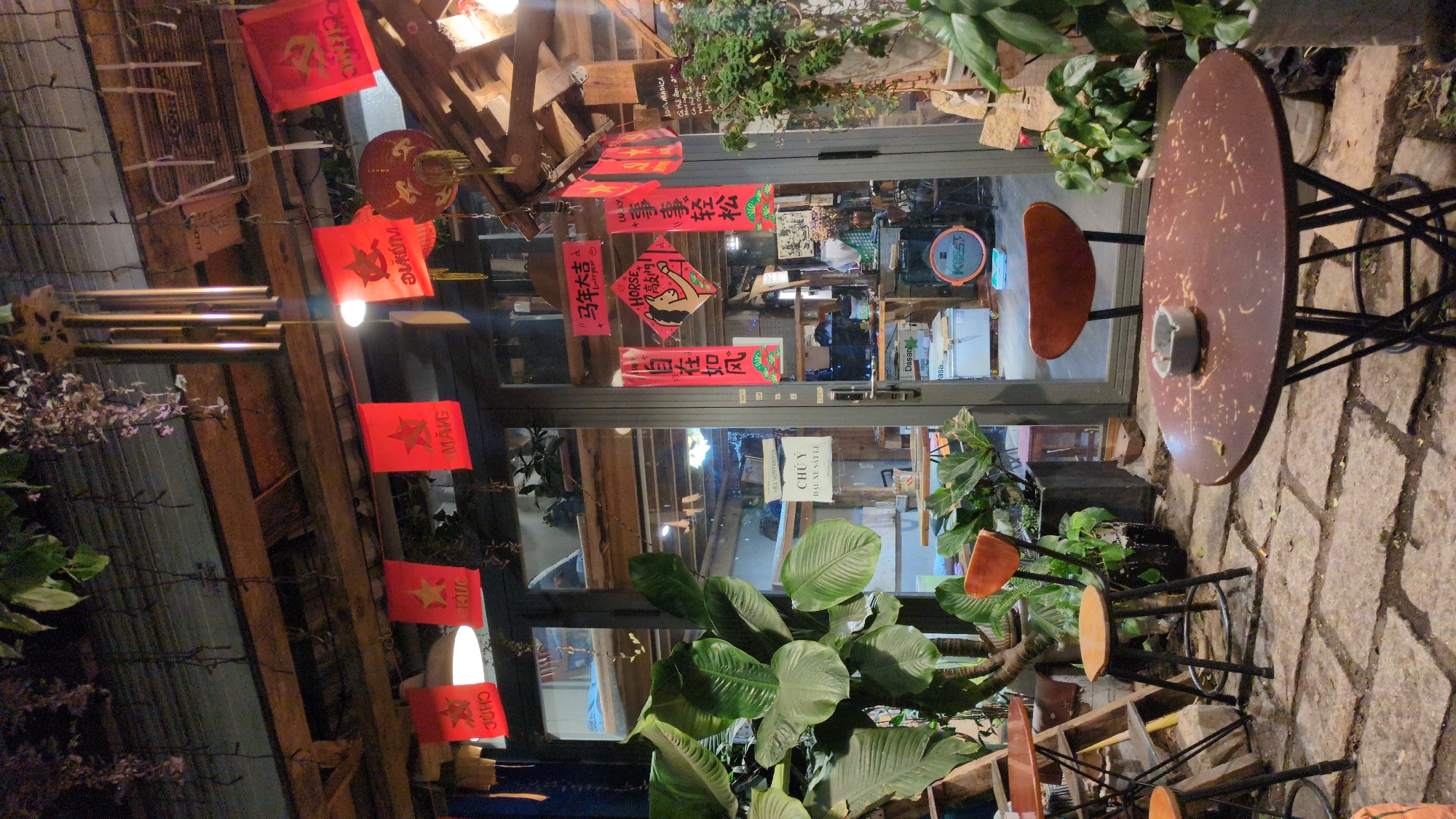 Business storefront with red signage photographed in Da Lat