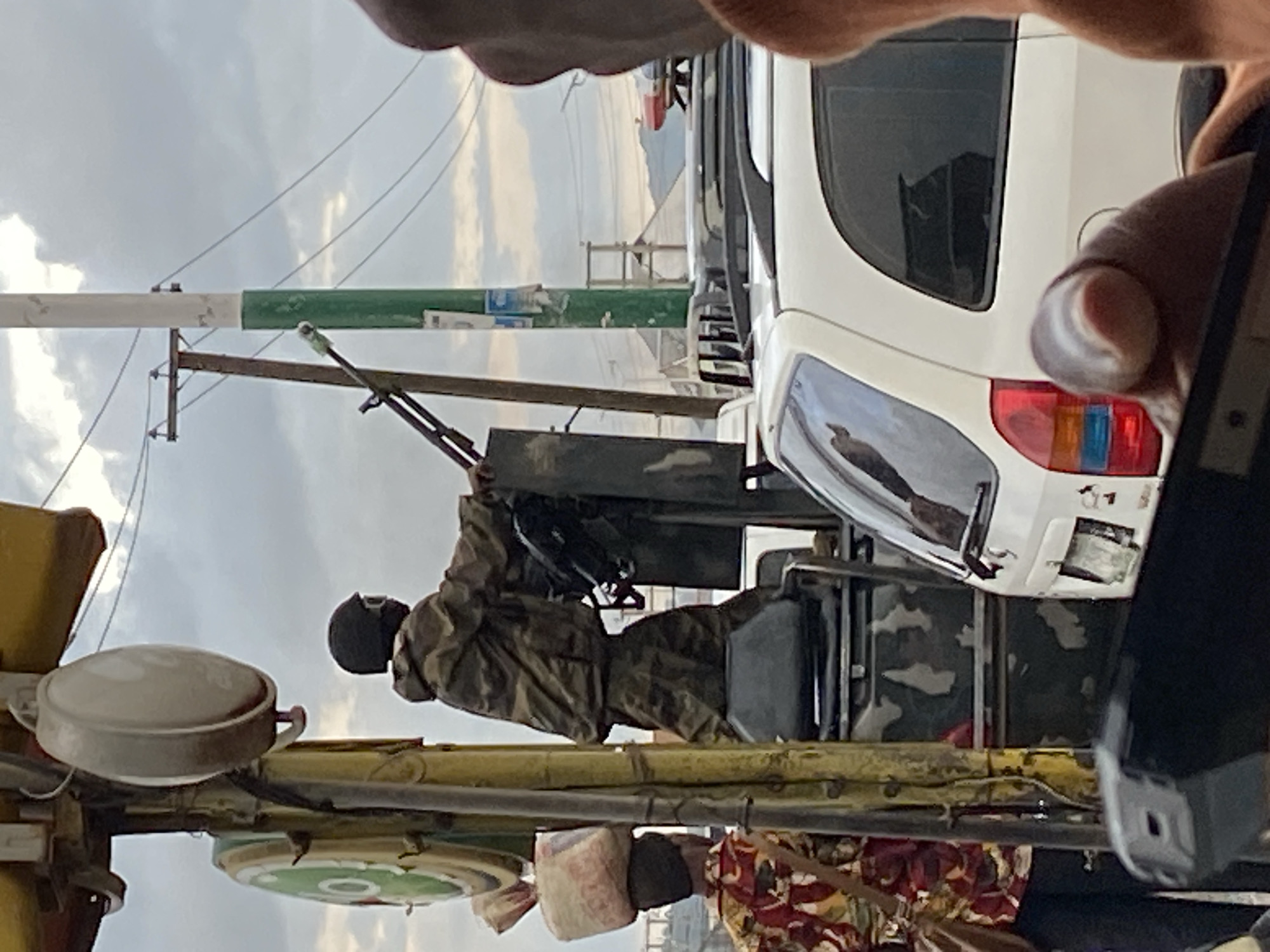 Military presence and market life mix on Bukuru streets