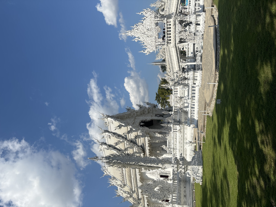 Visitors document Thailand's White Temple complex during morning hours