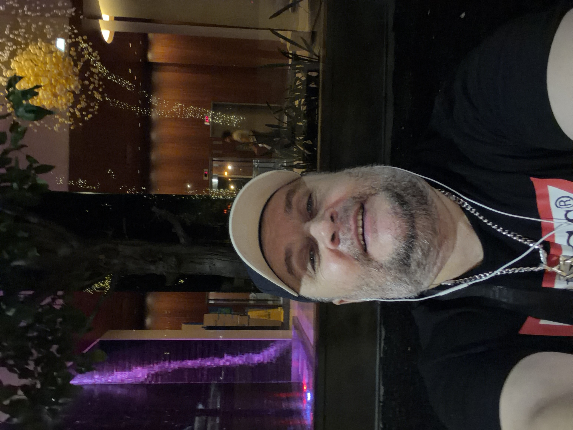 Late-night selfies at a lit fountain plaza in New York