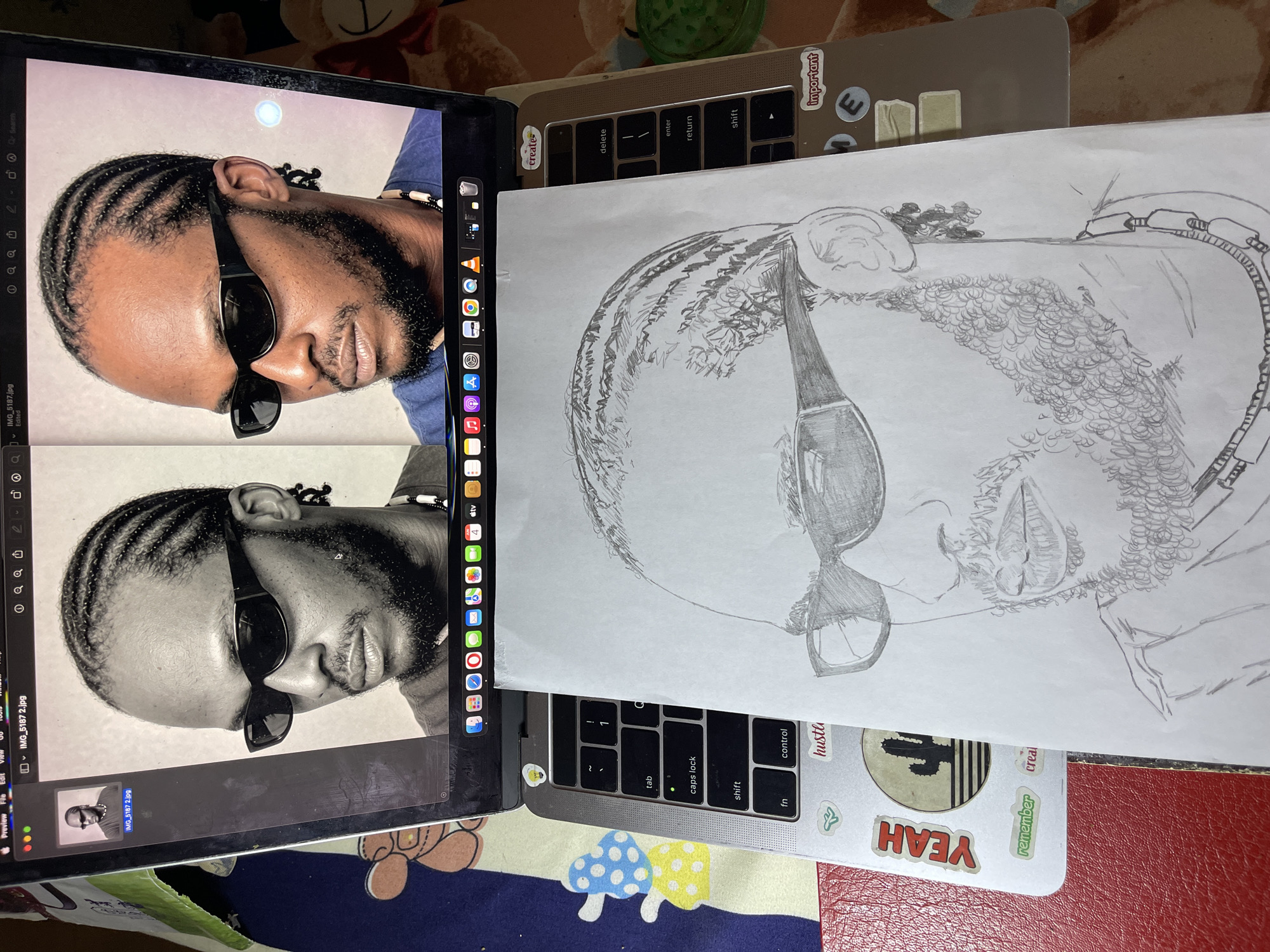 Artist sketches detailed portrait from laptop reference in Jos