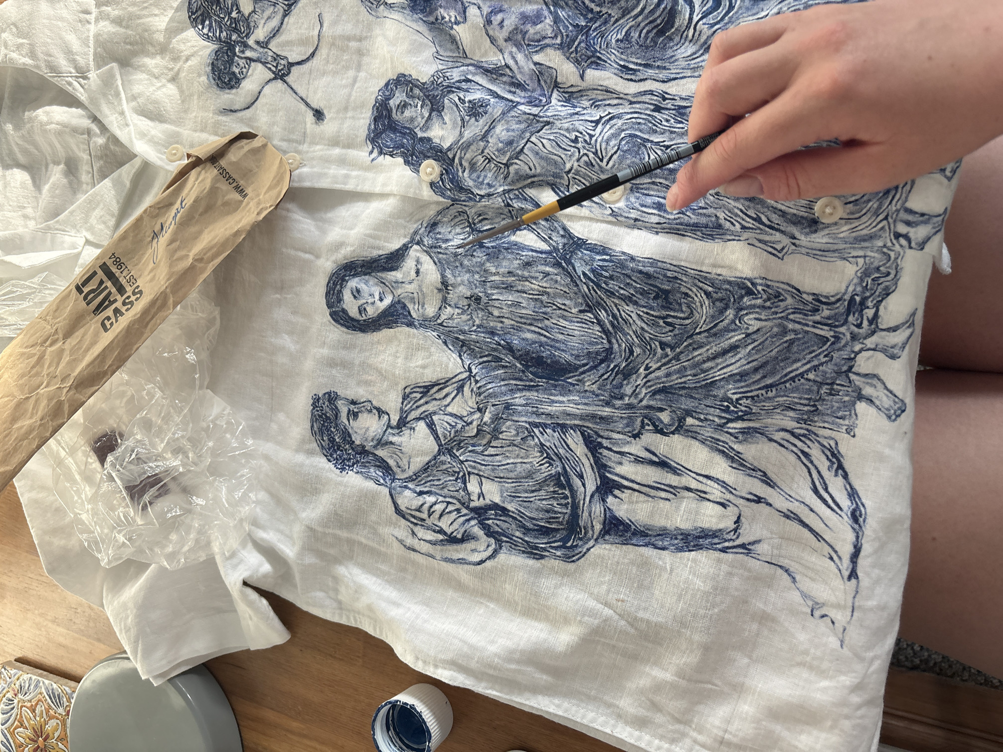 Artist works with fine brush in Manchester studio