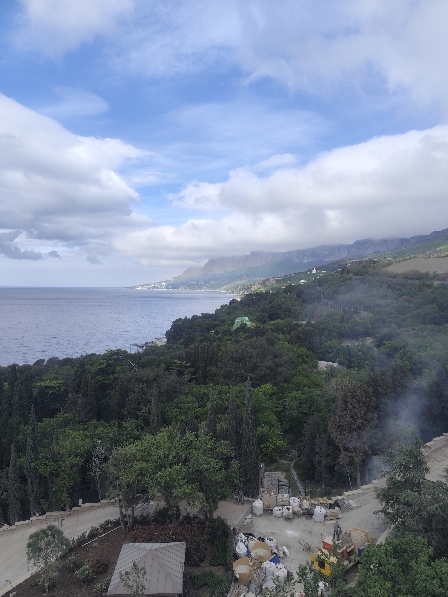 Coastal swimming pool construction observed near mountainous shoreline