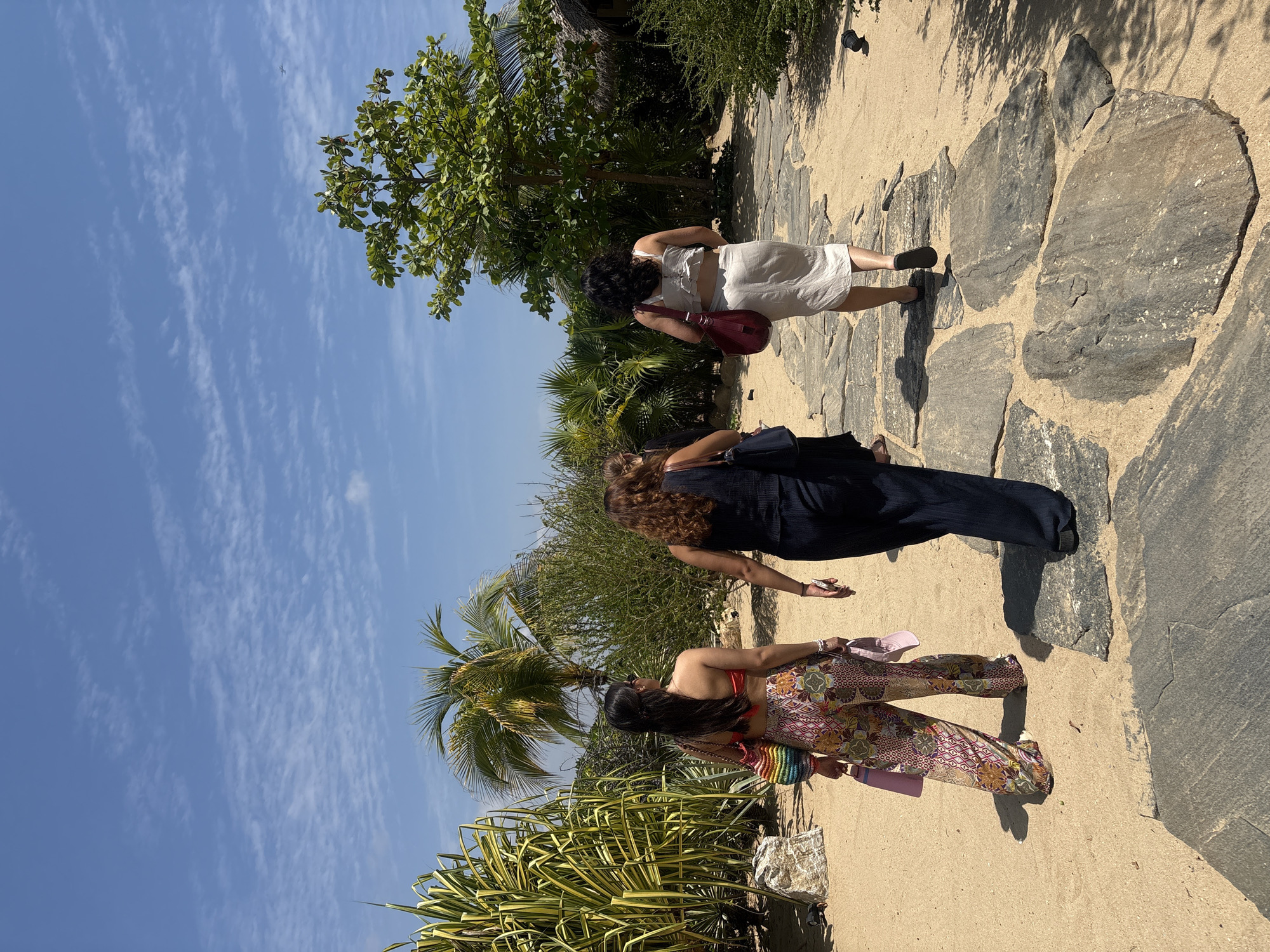 Women walk stone paths at Mexican cultural center