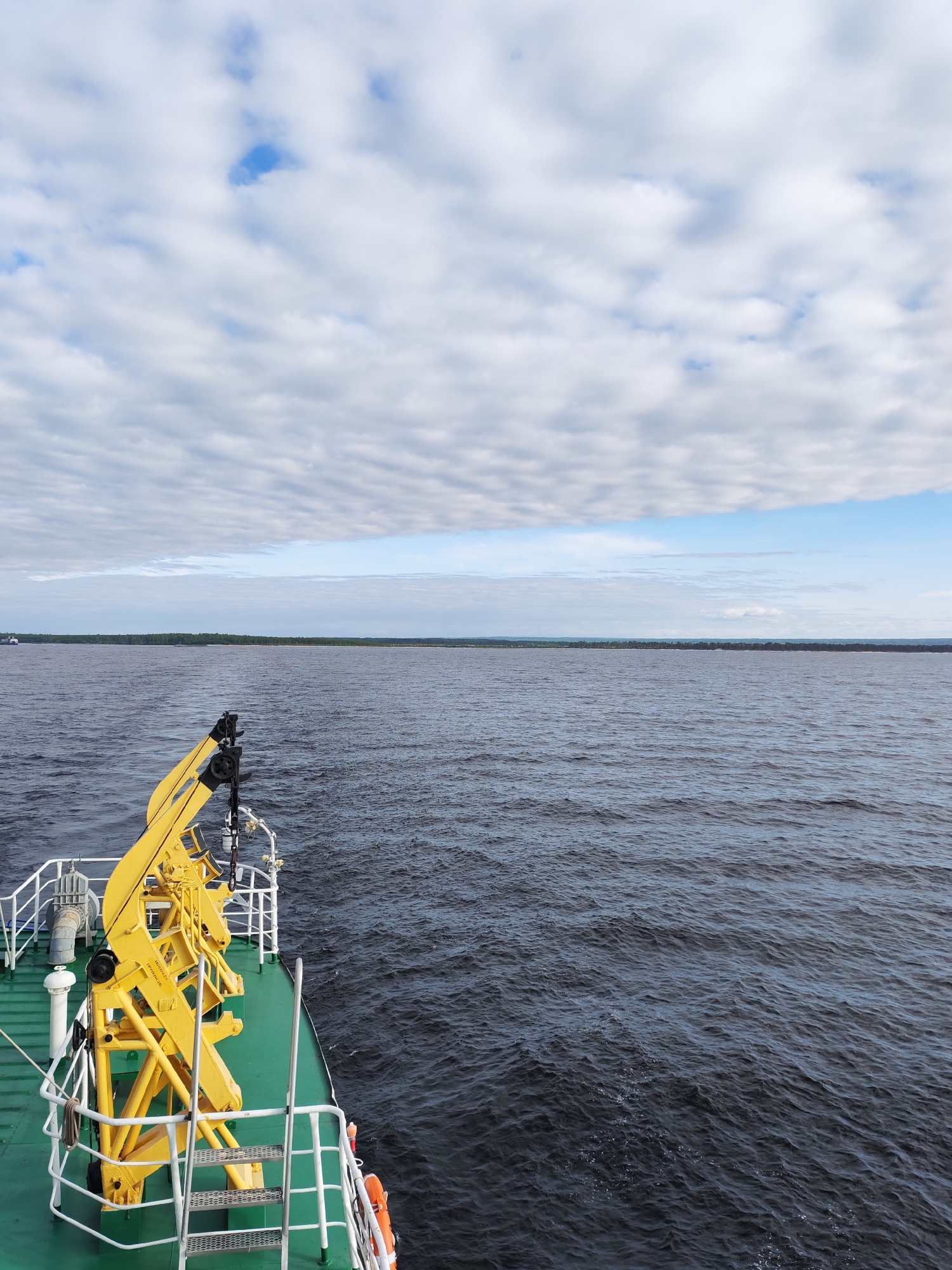 Boat passenger documents cloudy skies, rainbow effects in Ozernoe Ust'e