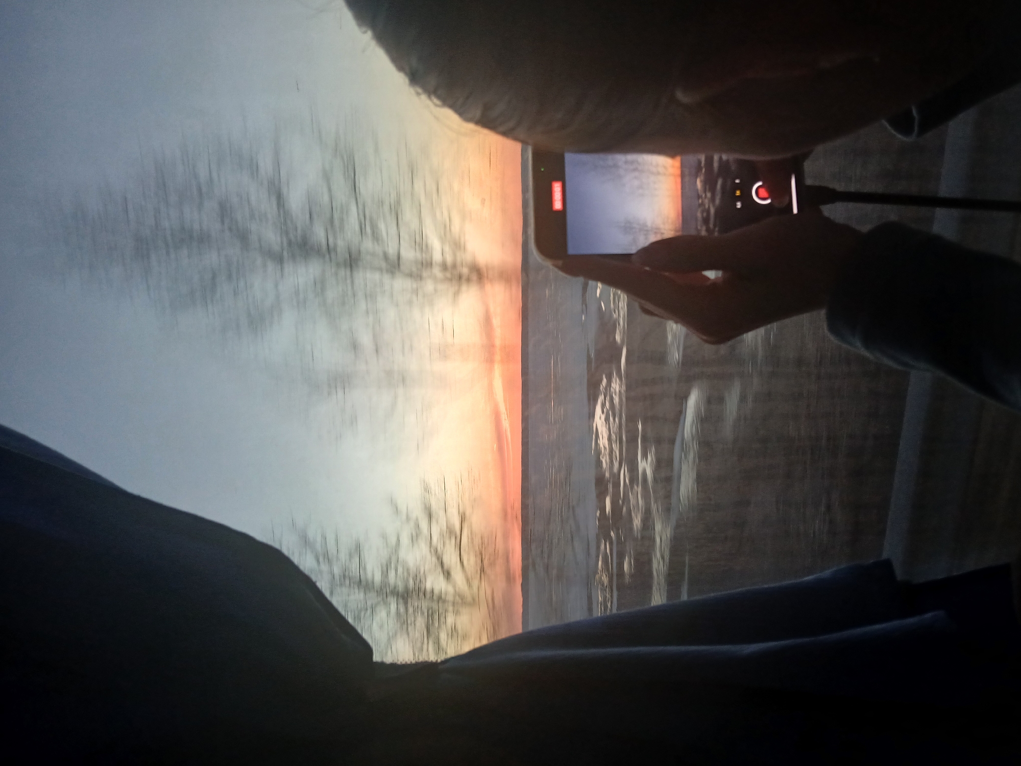 Person Films Winter Sunset on Smartphone in Kryukovo