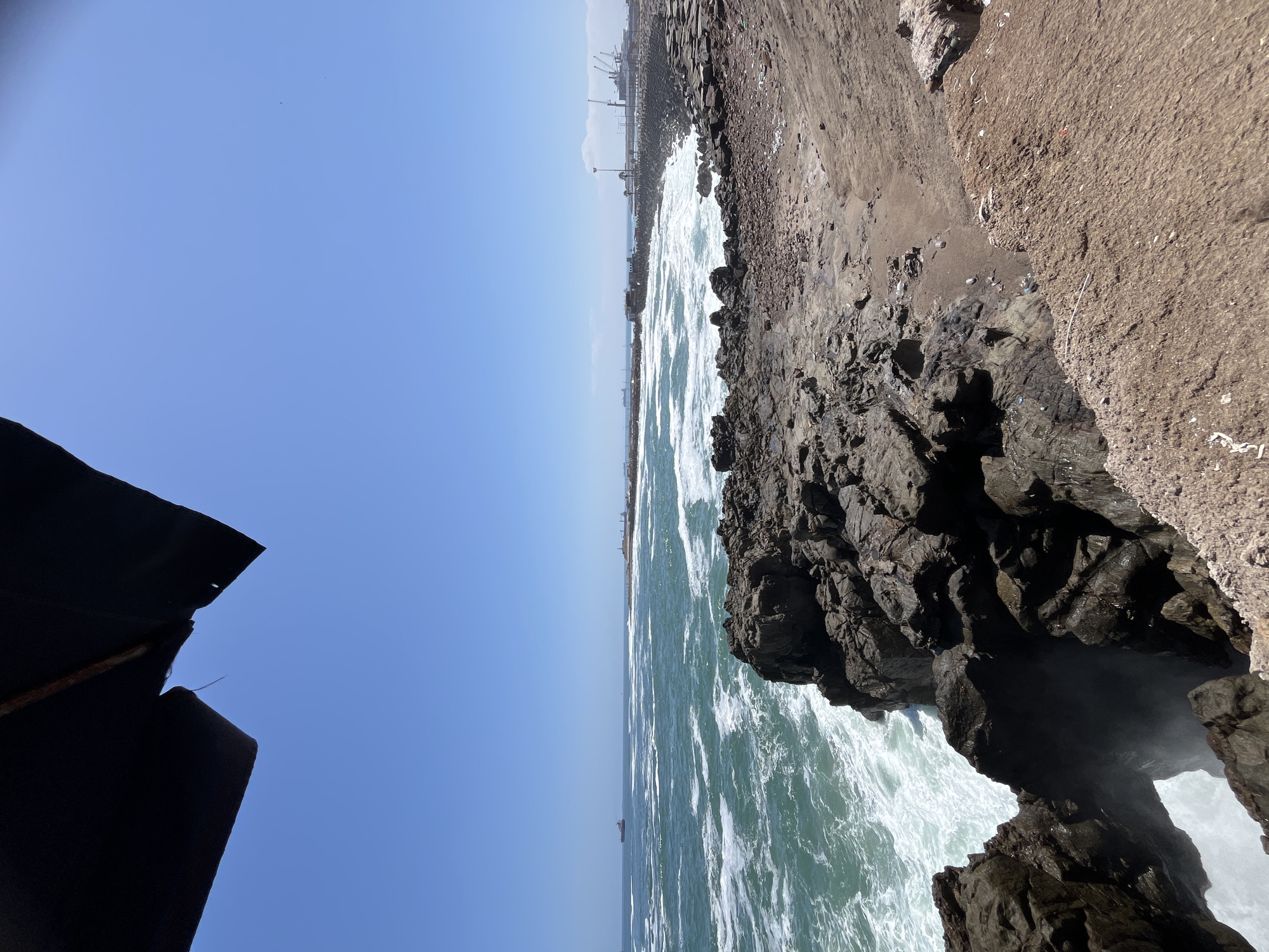 Waves crash against rocky Arica coastline, Chile