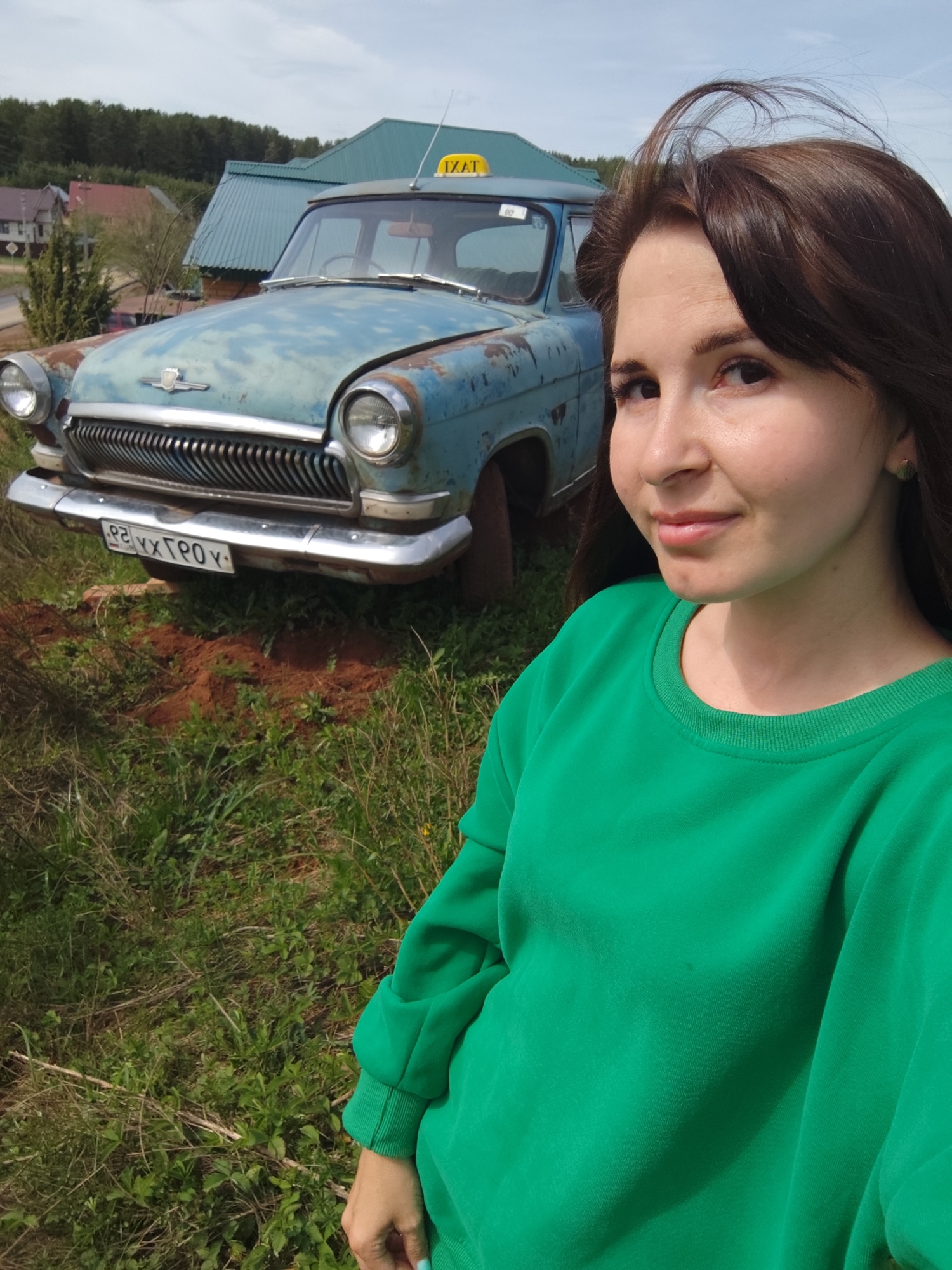 Village life documented in Фоки, Russia: woman, baby, abandoned taxi