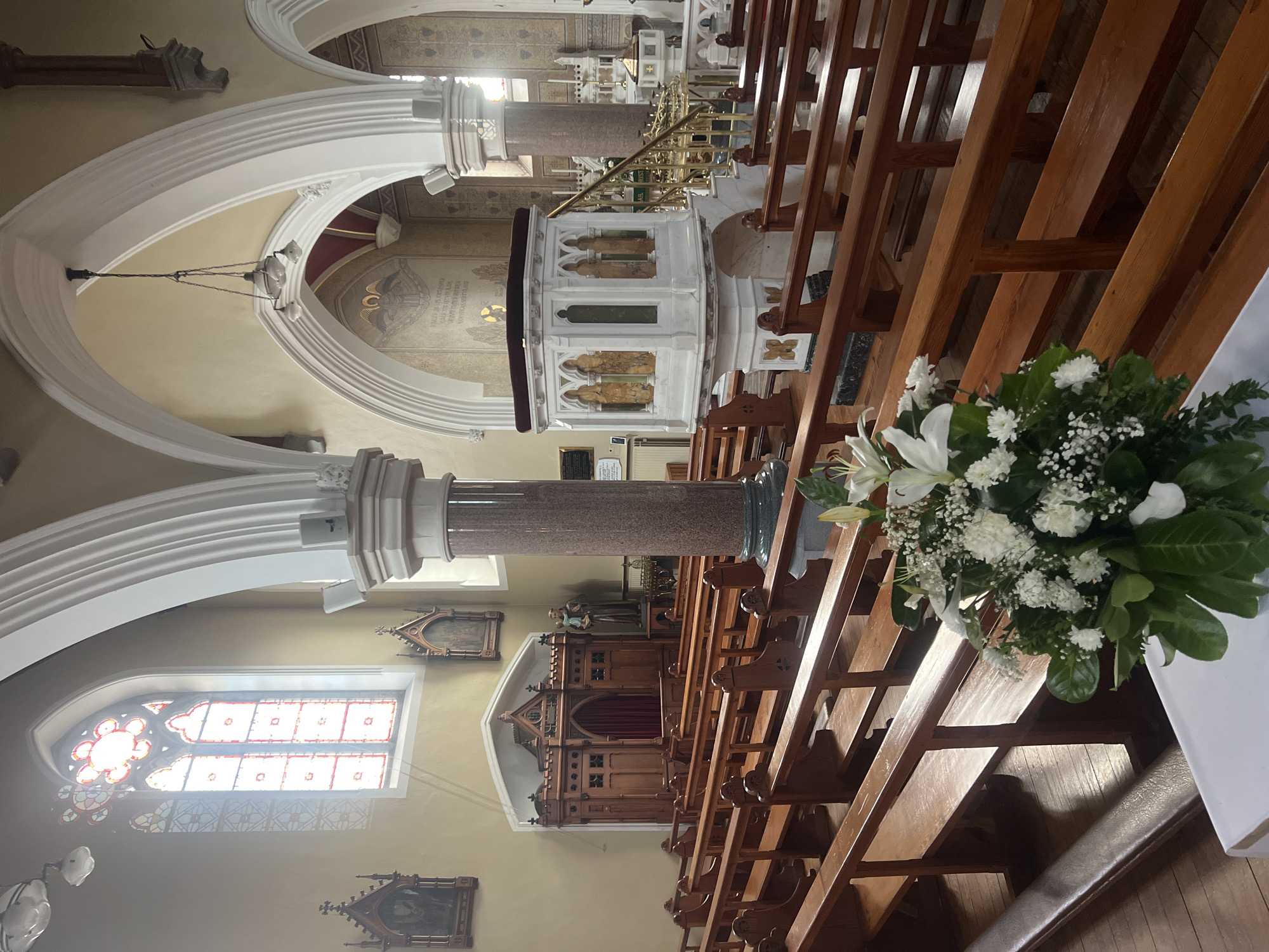 Church interior and florals, likely a memorial service