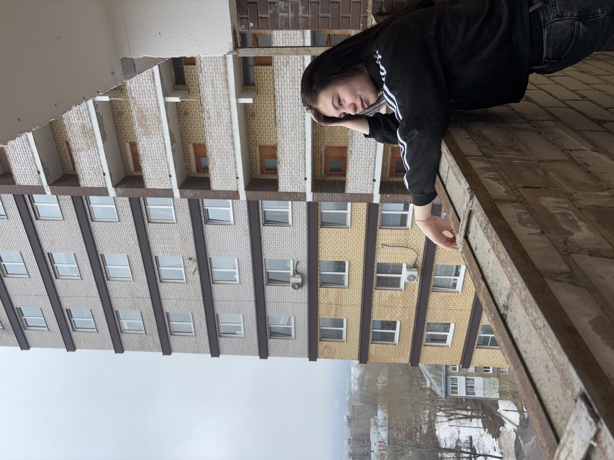 Two people explore unfinished building in Perm, Russia
