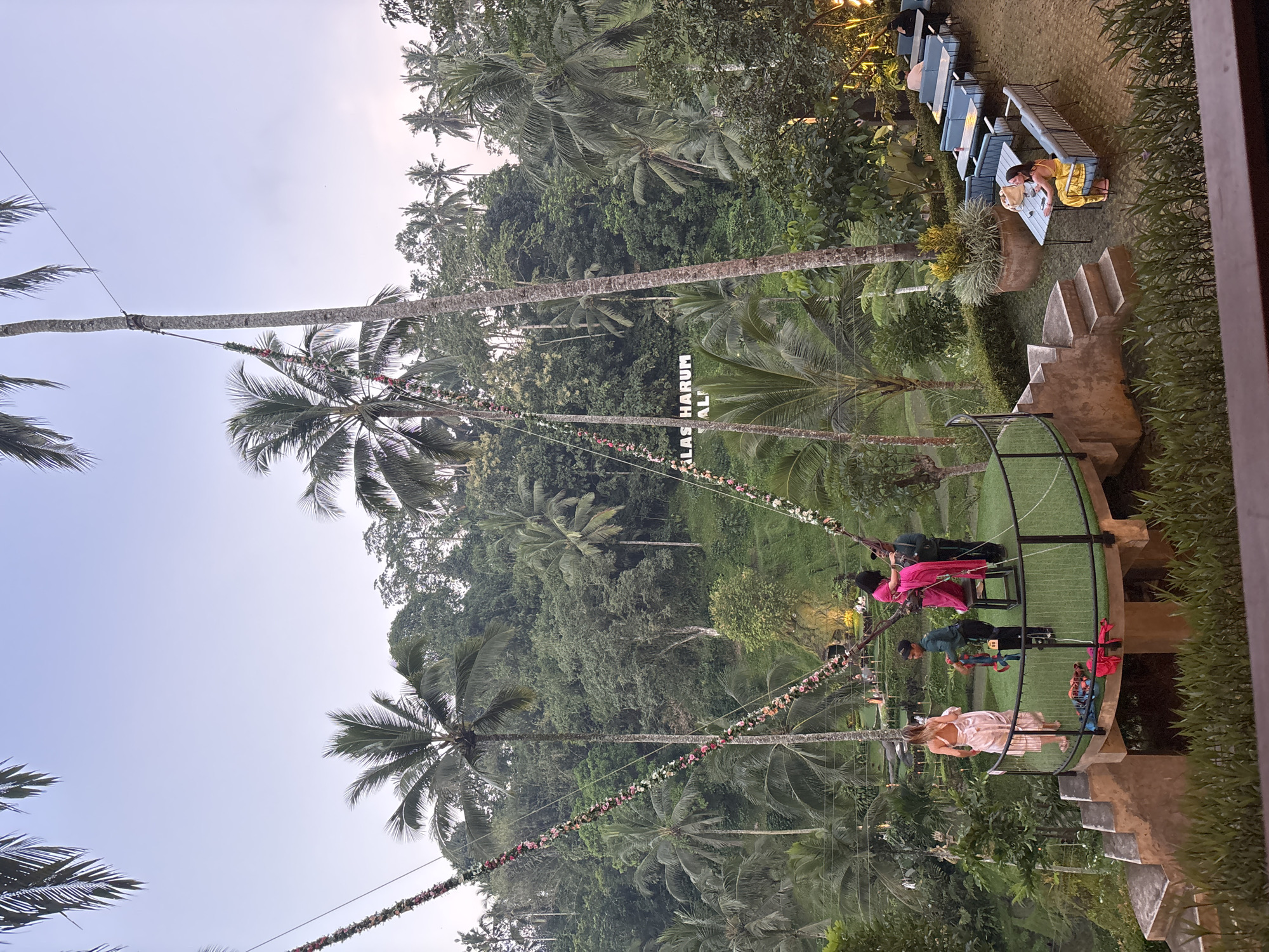 Tourists enjoy swings and view elephant statue in Tegallalang