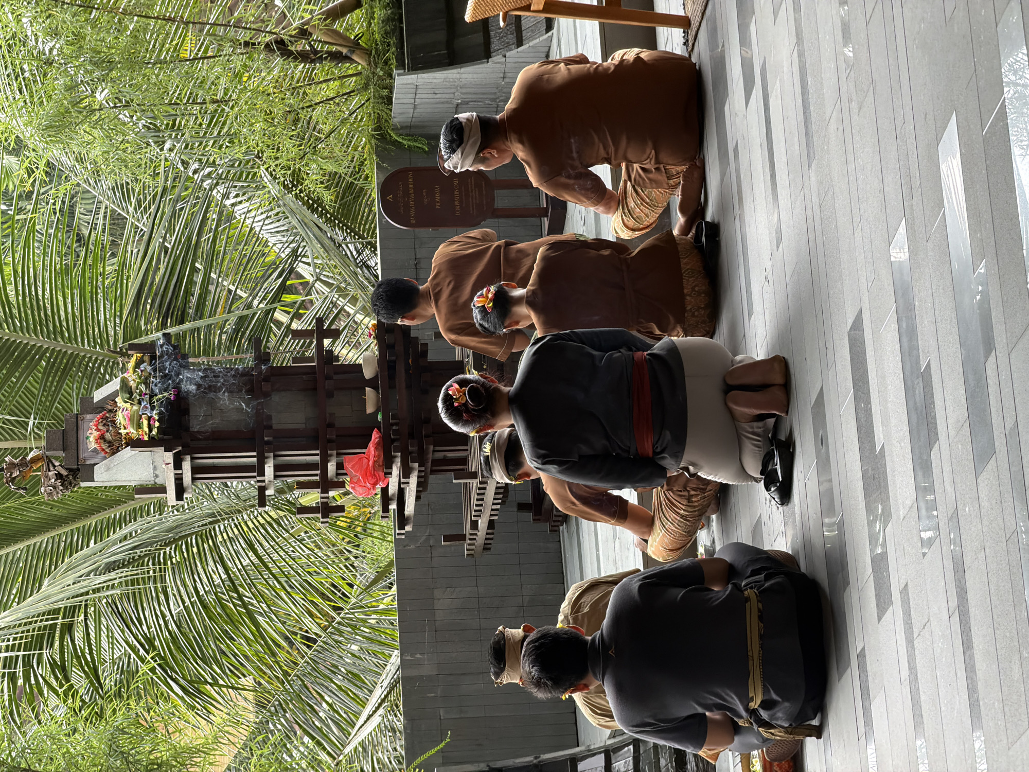 Balinese ceremony with shrine offerings and ritual food displays