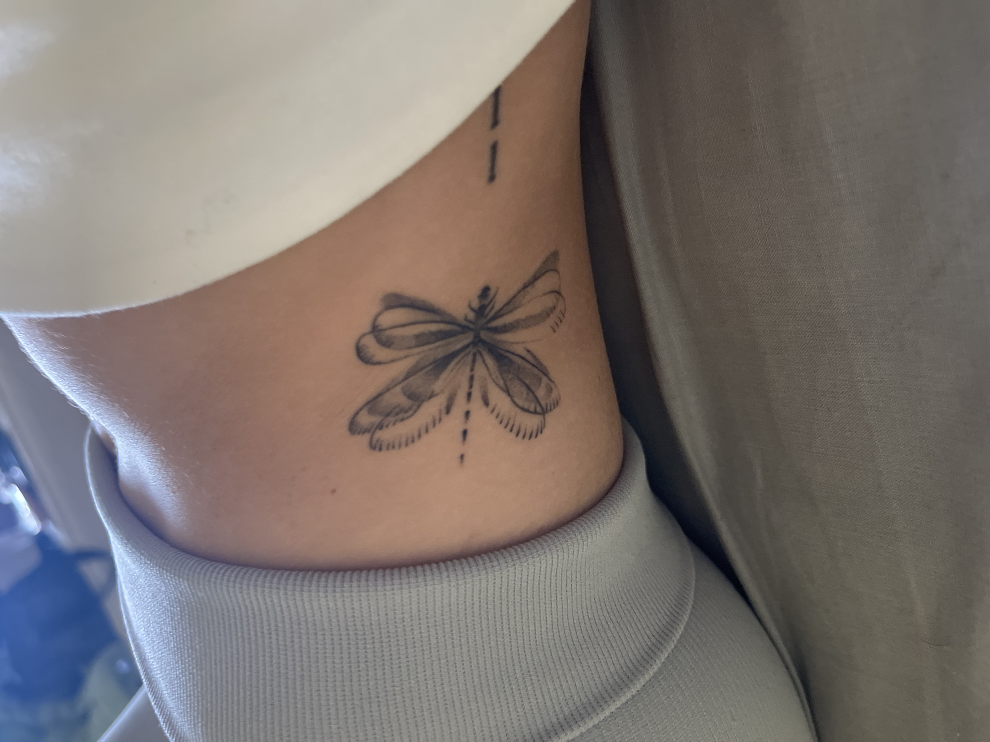 Woman documents afternoon selfie session showing athletic wear and tattoos