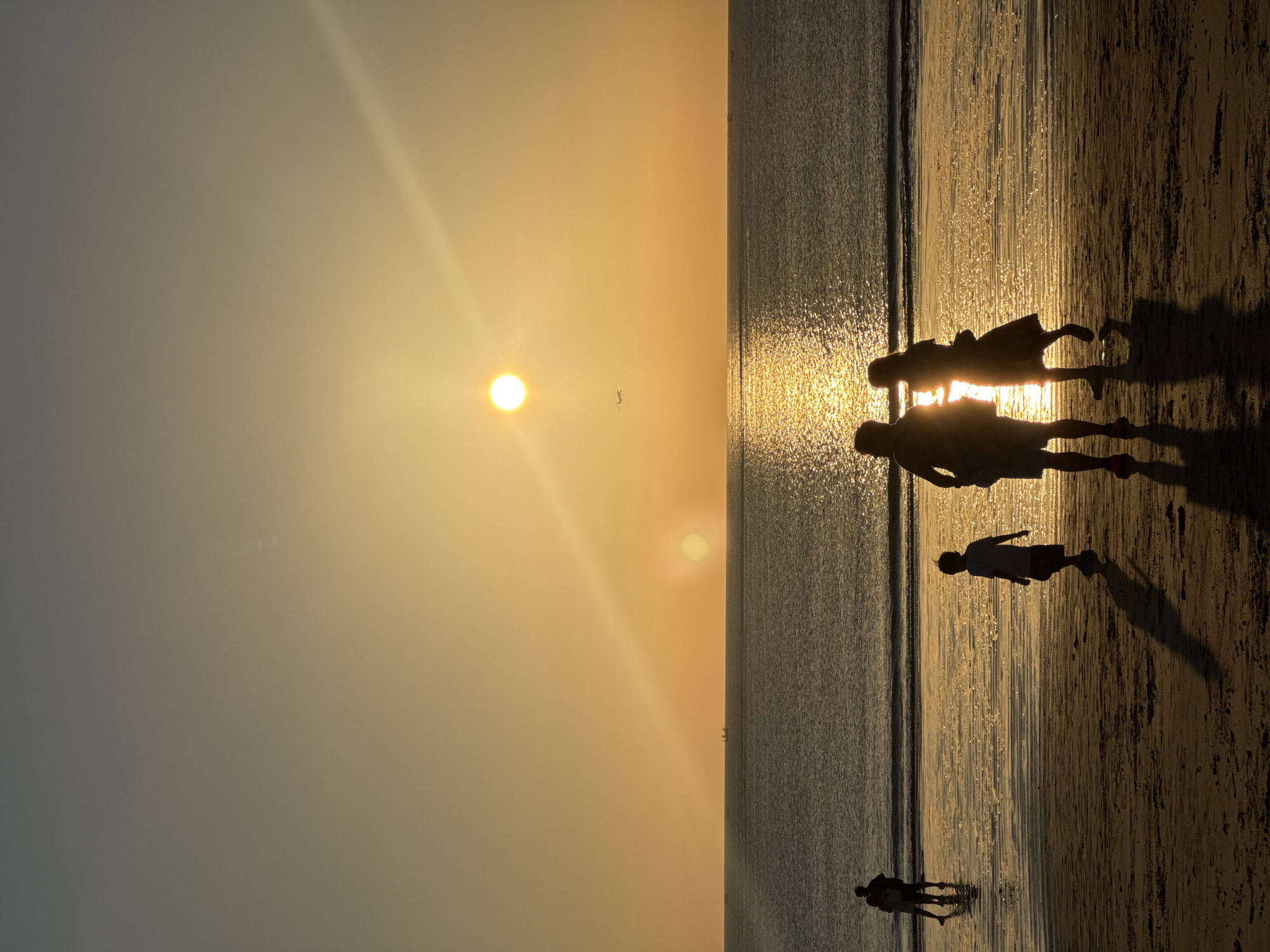 Kuta Selatan beach at golden hour, crowds and kites included