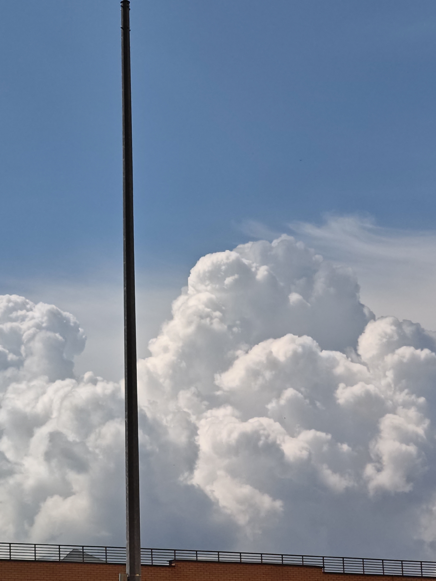 Summer sky and rooftops in Shcherbinka, seen from below