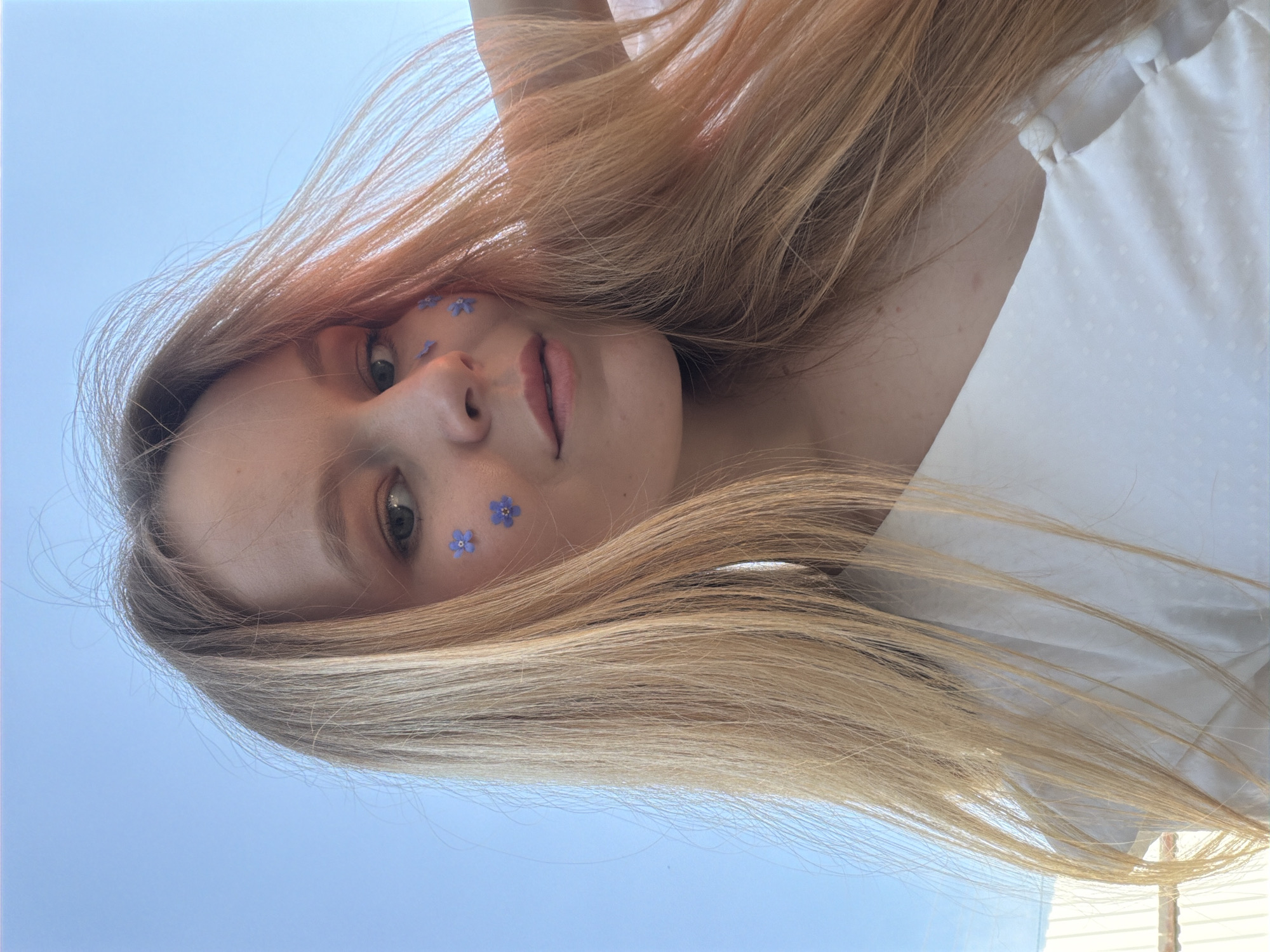 Woman poses with blue flowers in Russian field photoshoot