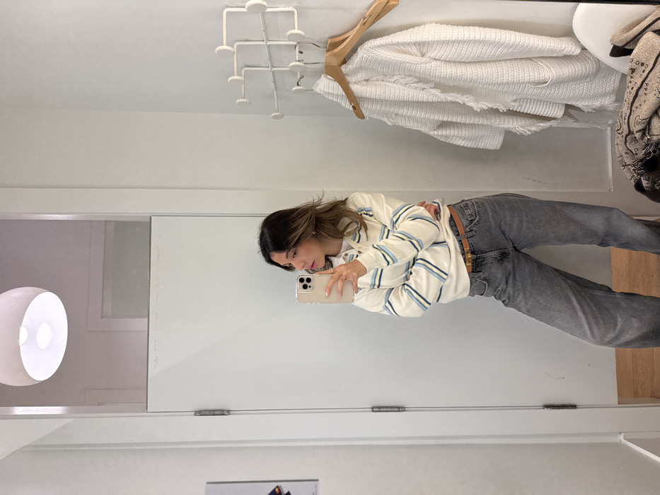 Woman documents shopping trip through multiple mirror selfies