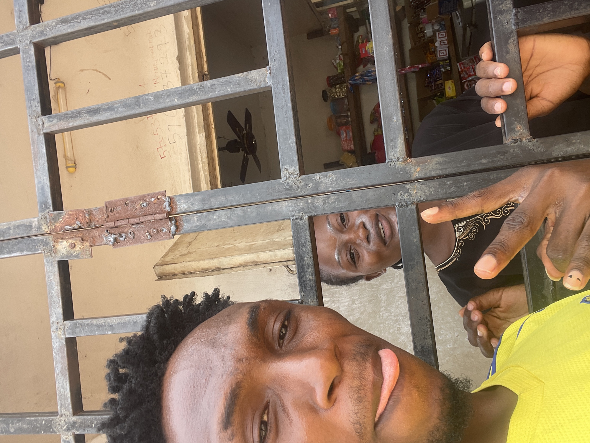 Shop interactions captured through security bars in Lokoja