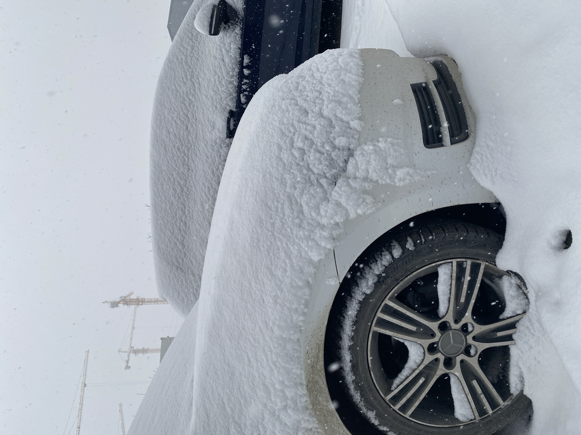 Heavy snow blankets parked cars on Yekaterinburg street