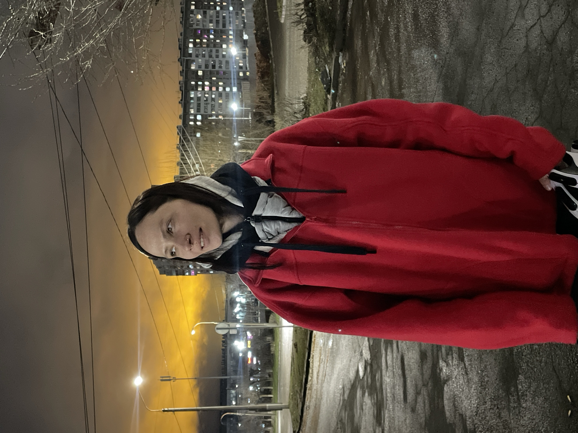 Woman stands outdoors at night in Izhevsk, Russia