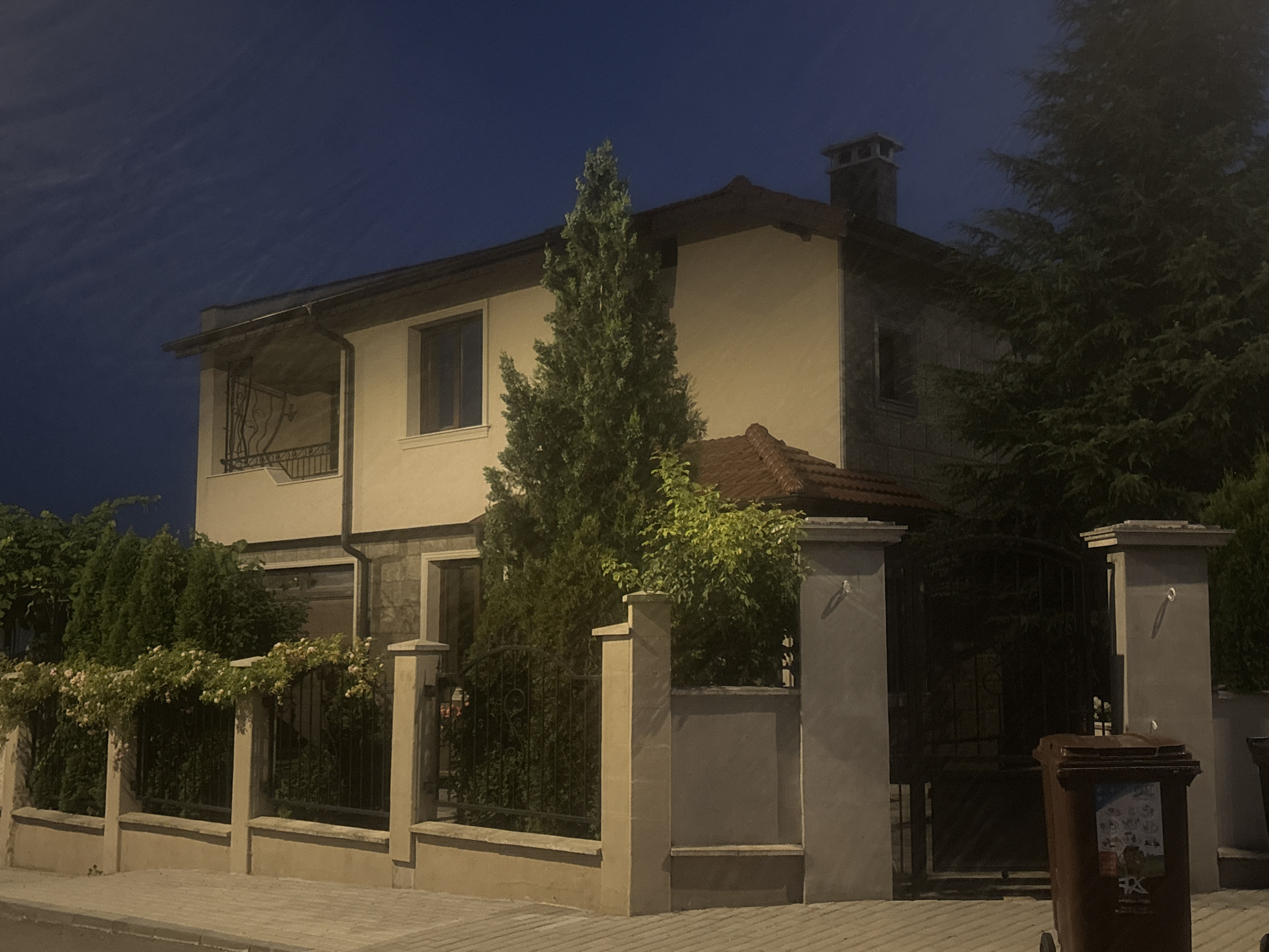 Quiet residential street in Burgas at dusk, SUV parked outside