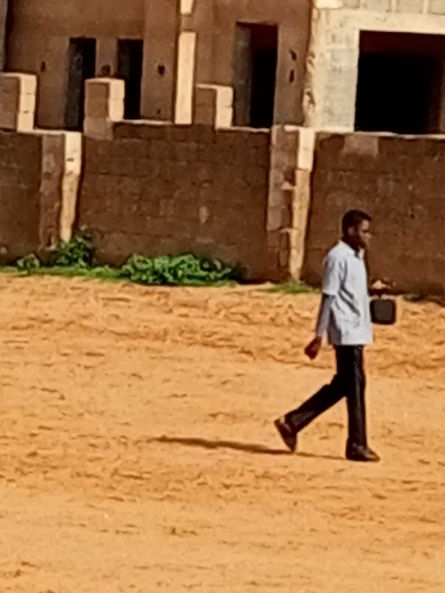 Quiet morning activity around a brick building in Tempure, Nigeria