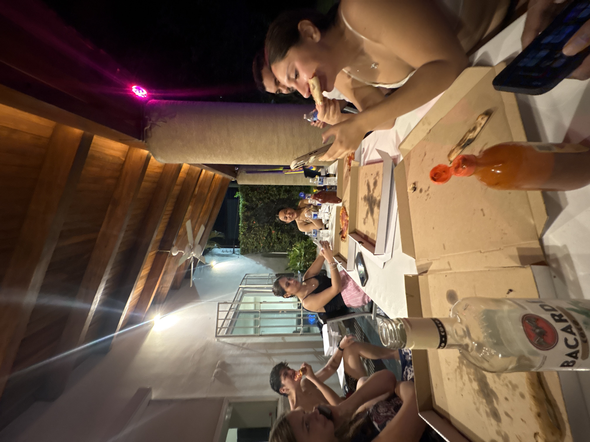 Late night pizza gathering on patio in Puerto Escondido