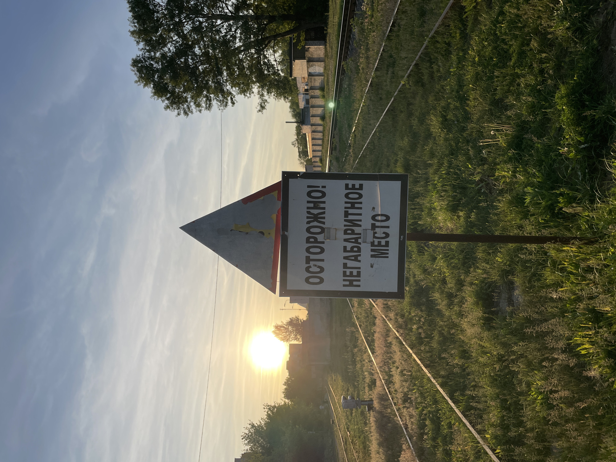 Person documents railway areas during evening walk in Brest