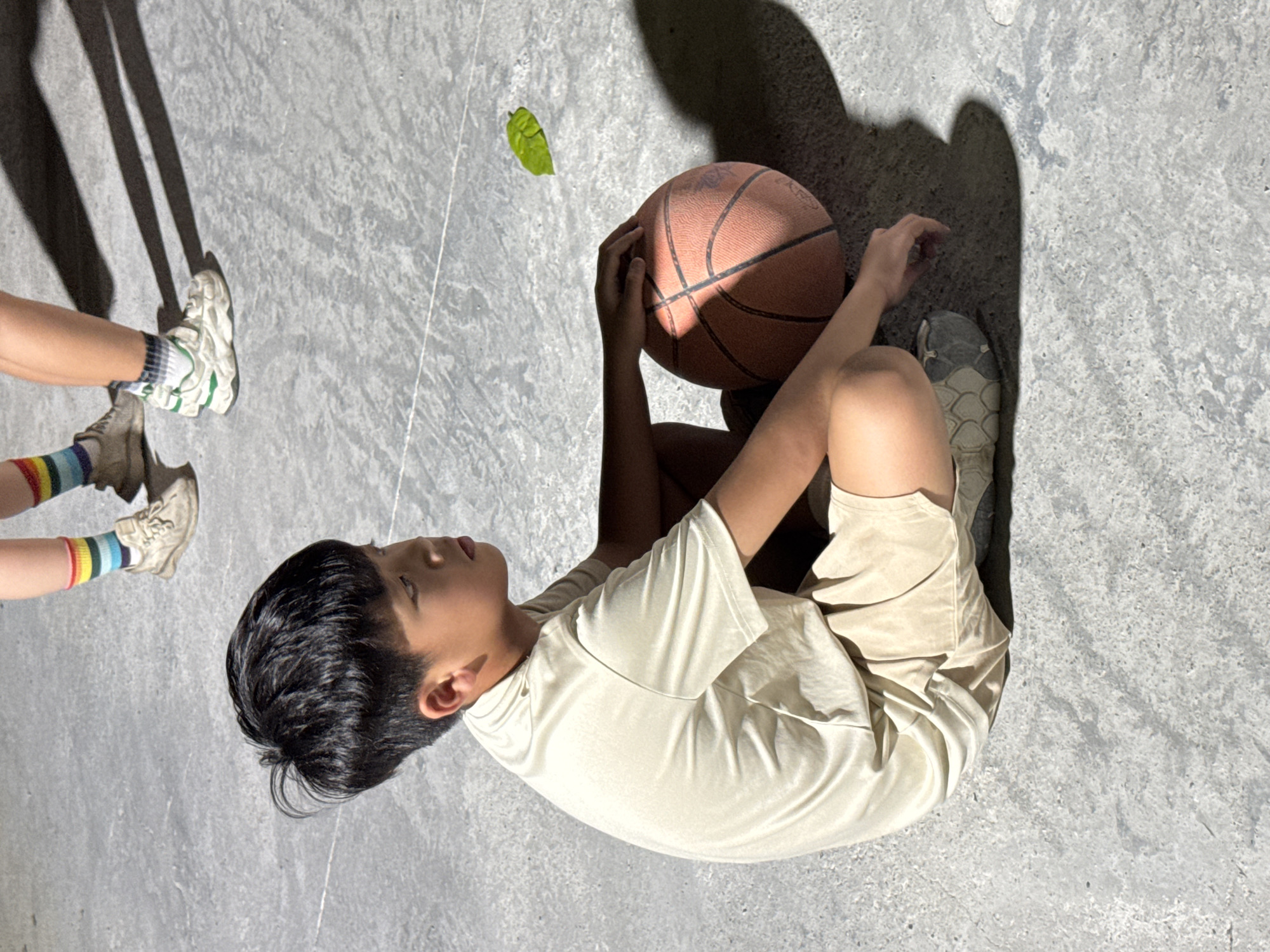Youth basketball practice on a lit outdoor court in Nha Trang