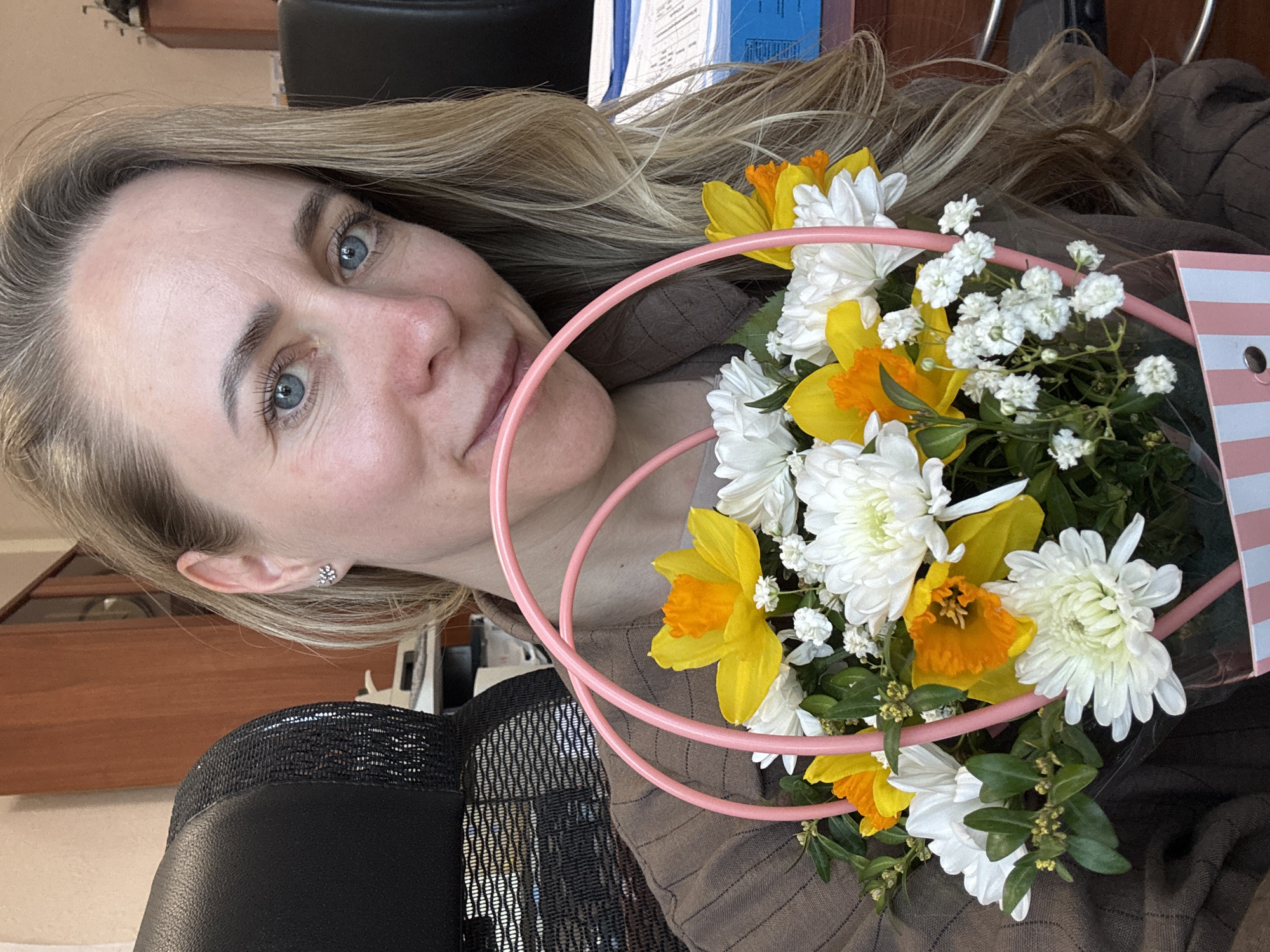 Woman holds spring flower bouquet in Chaikovsky, Russia