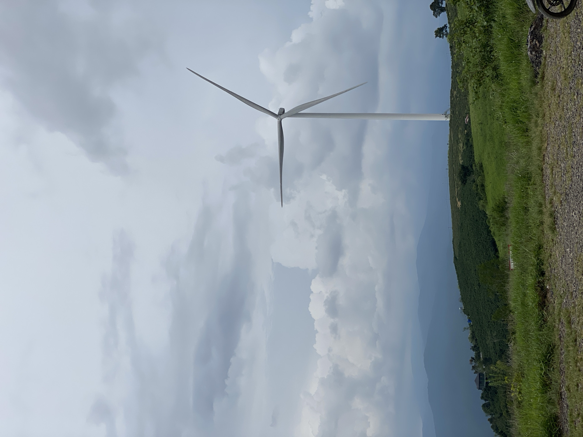 Wind turbines across the misty hills of Trường Thọ, Vietnam