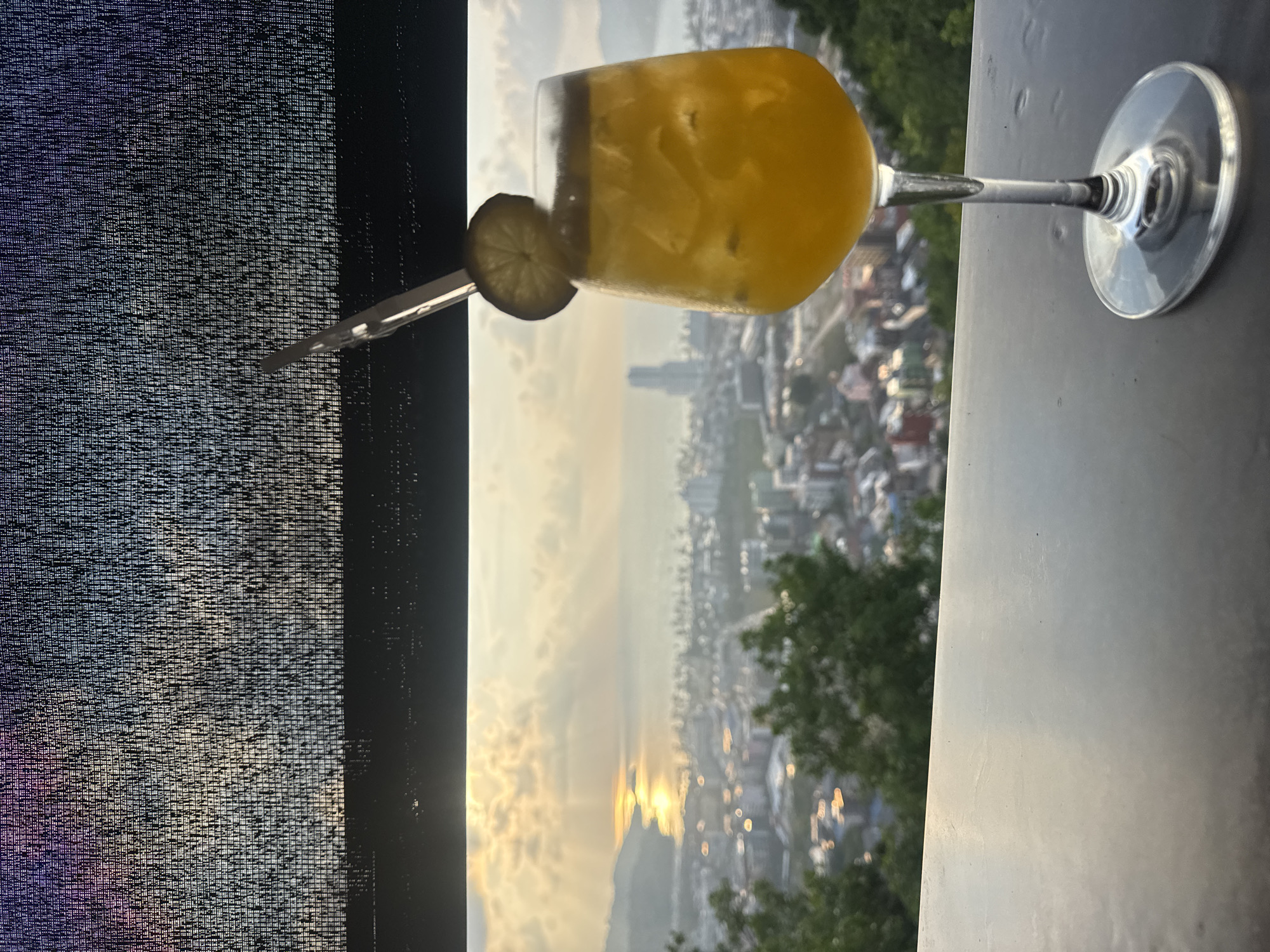 Sunset cocktails captured from elevated Patong restaurant balcony