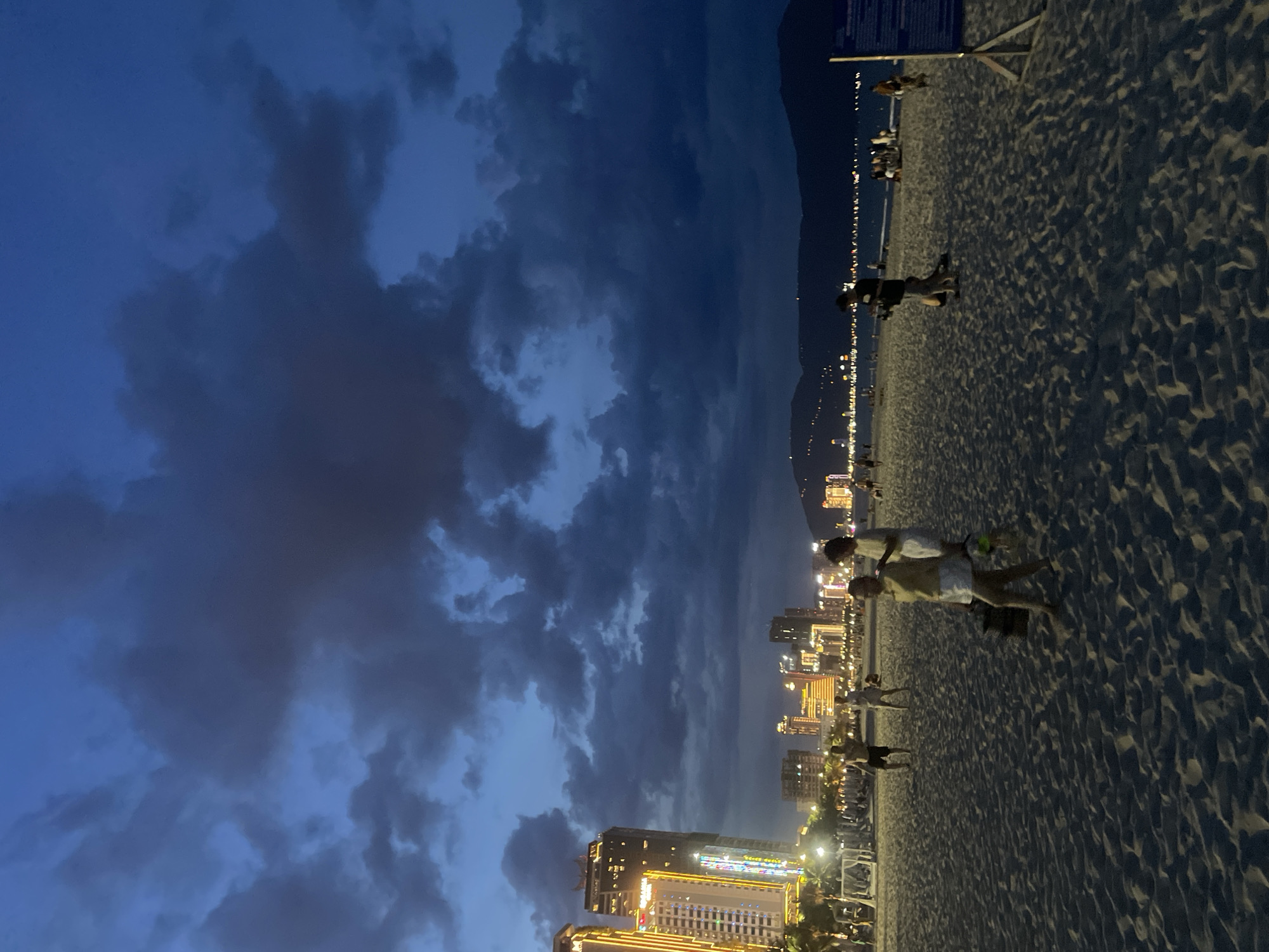 Da Nang beach at dusk, parasailing and city lights