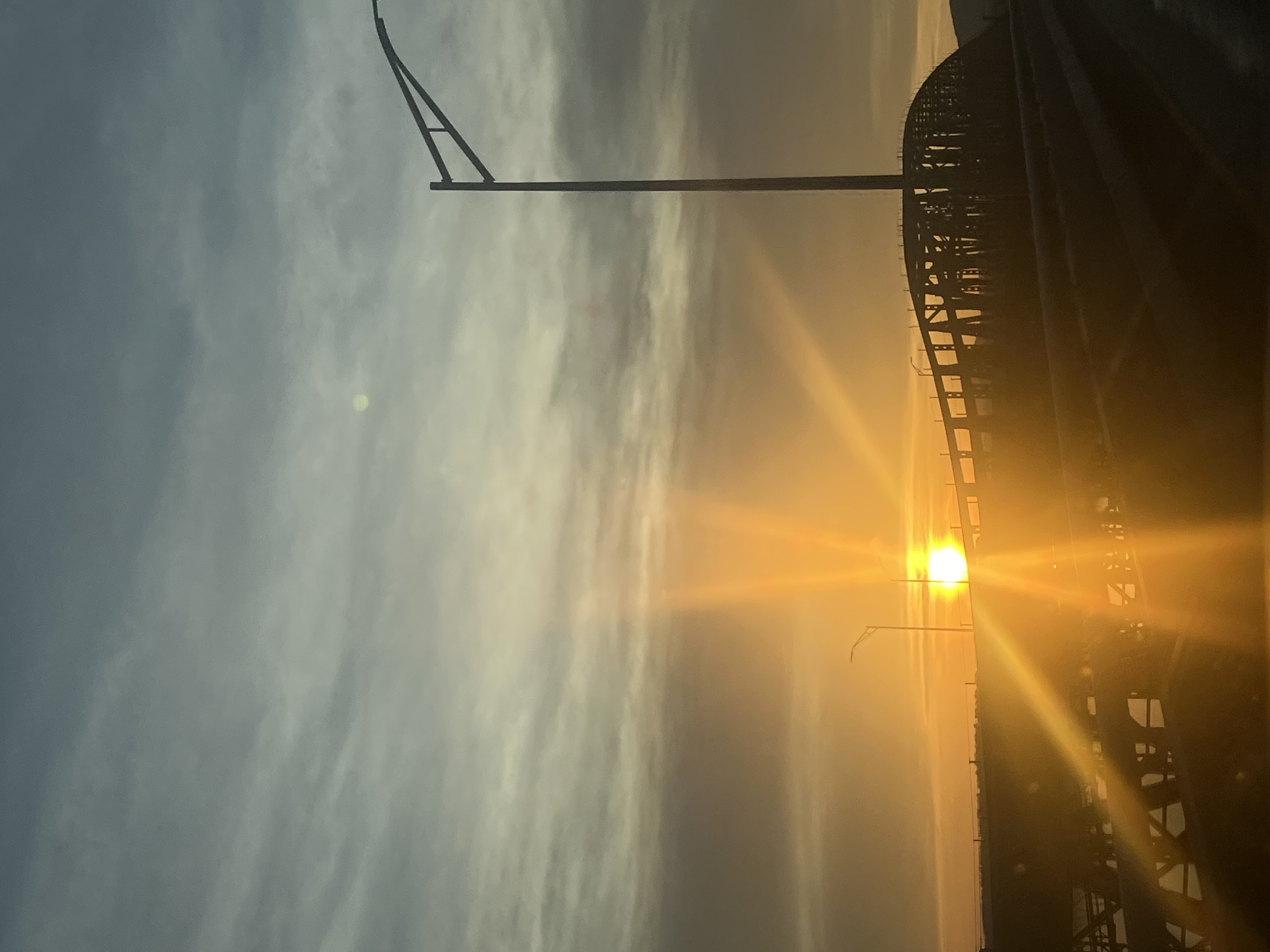 Sunset traffic observed on Newburgh bridge amid colorful sky