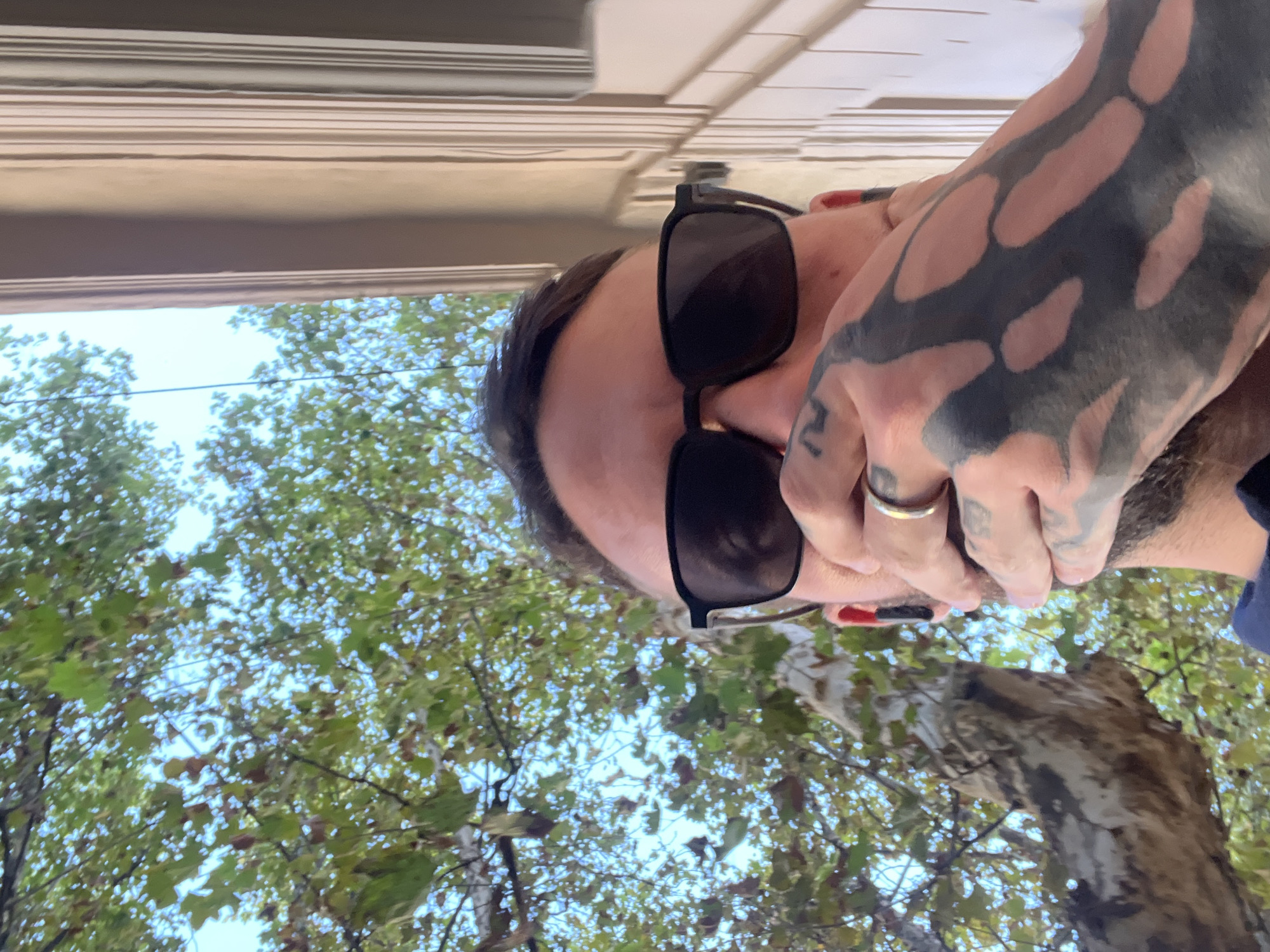 Tattooed man takes selfies in Cordoba elevator and outdoors