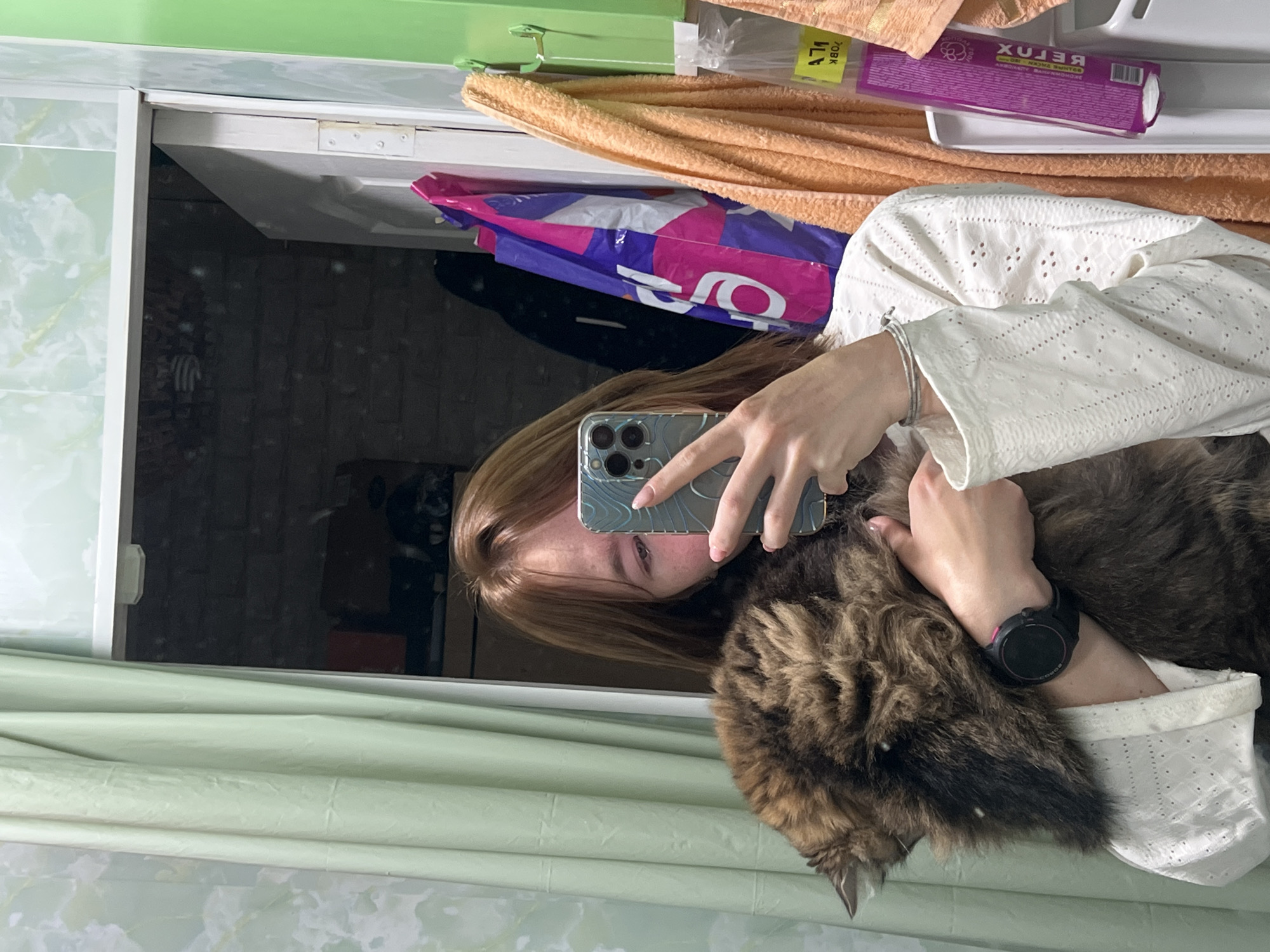 Woman takes mirror selfies with cat in Chaikovsky bathroom