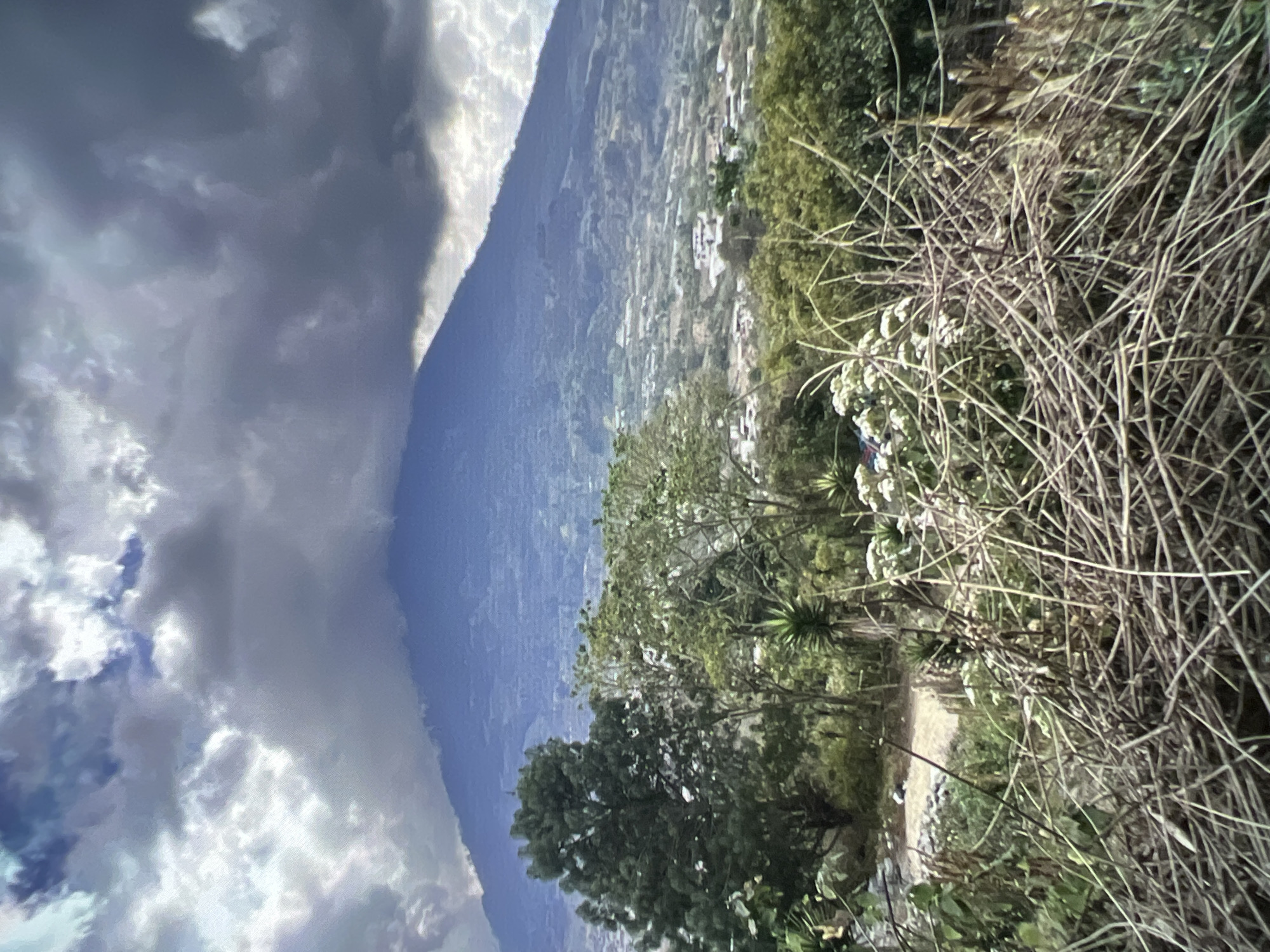 Stormy mountain peak and colorful cobblestone street, same moment