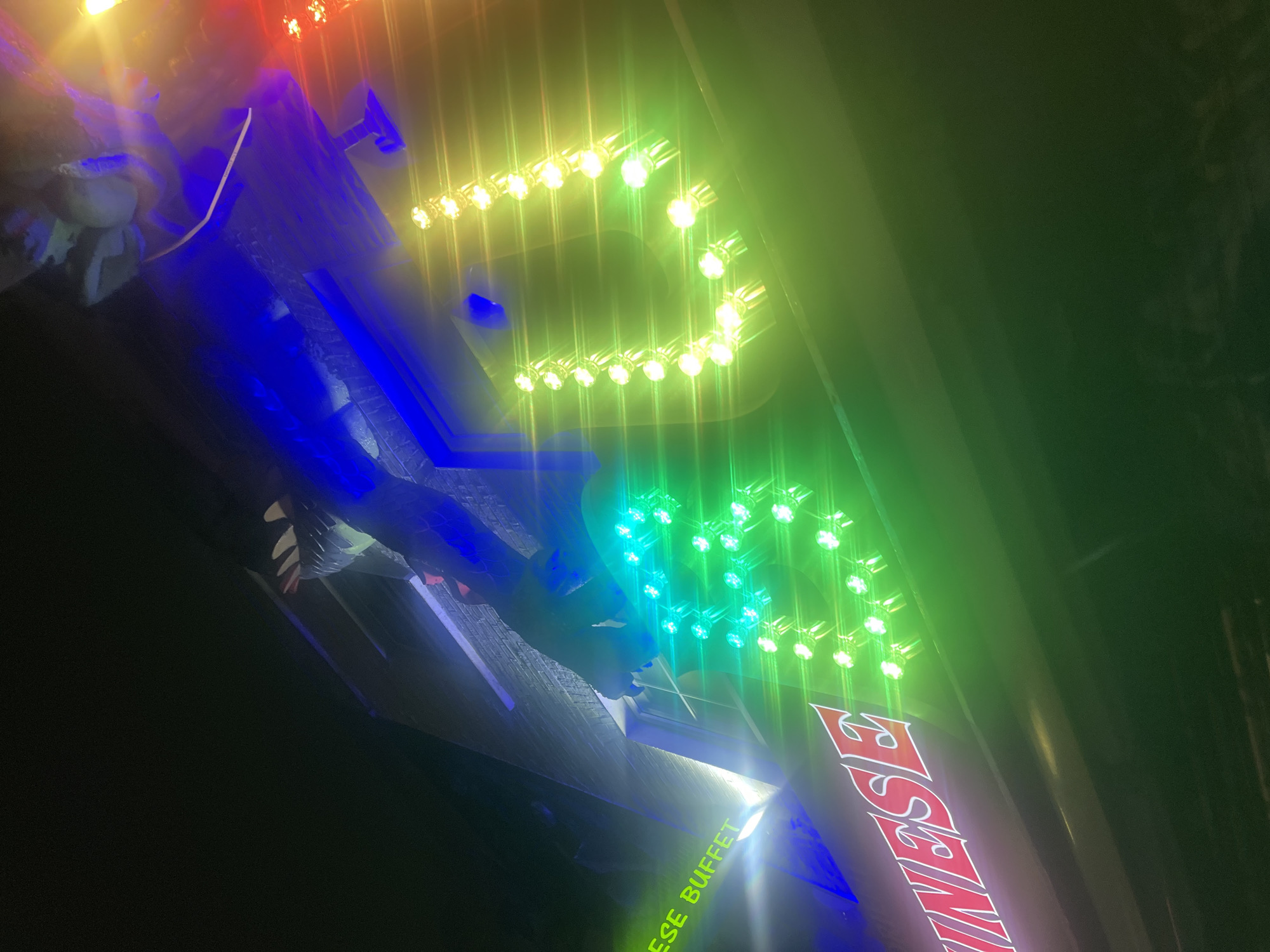 London witness captures illuminated Chinese buffet sign, hand gesture