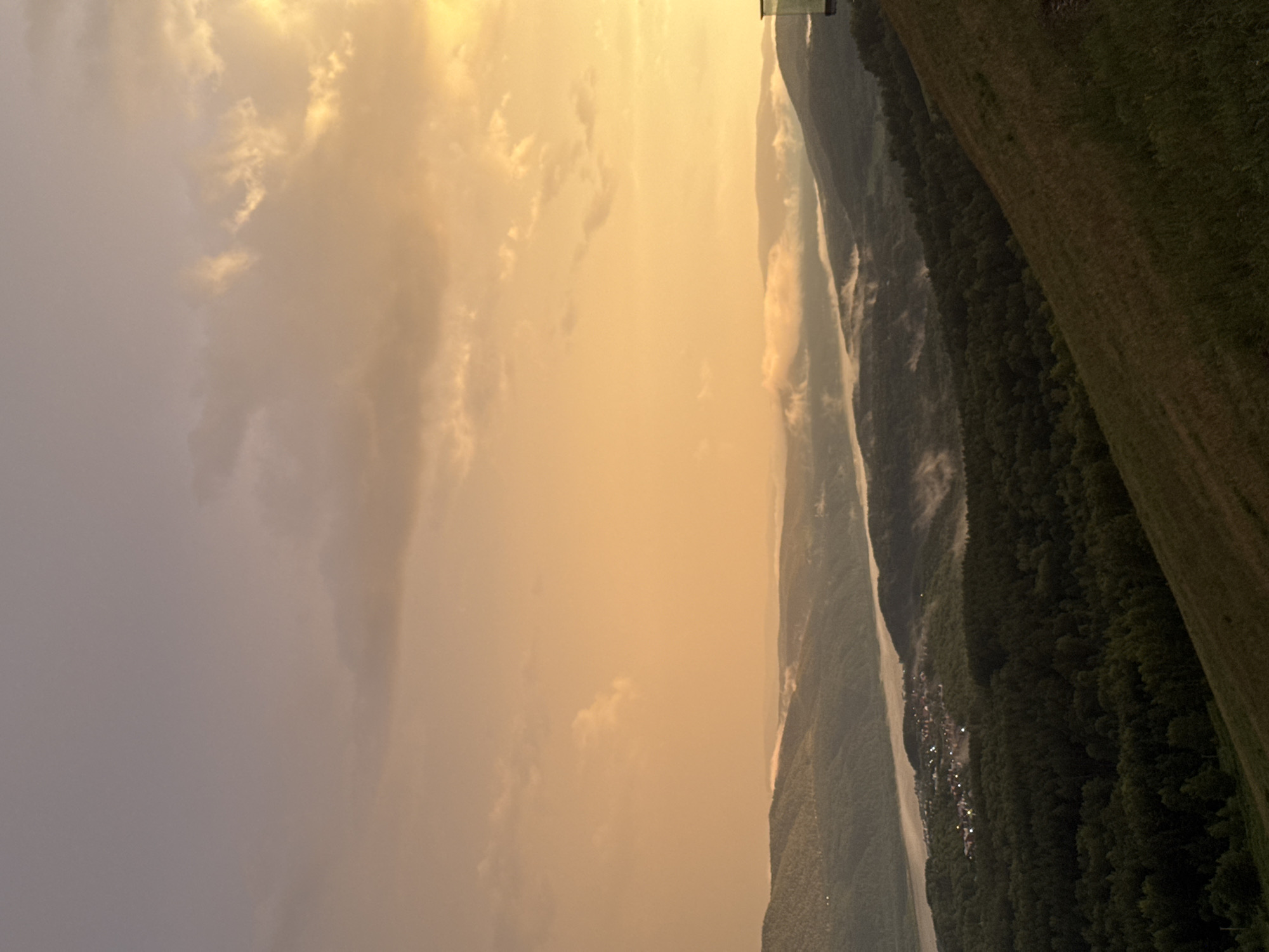 Rainbow over Krasnoyarsk at golden hour, Yenisei River below
