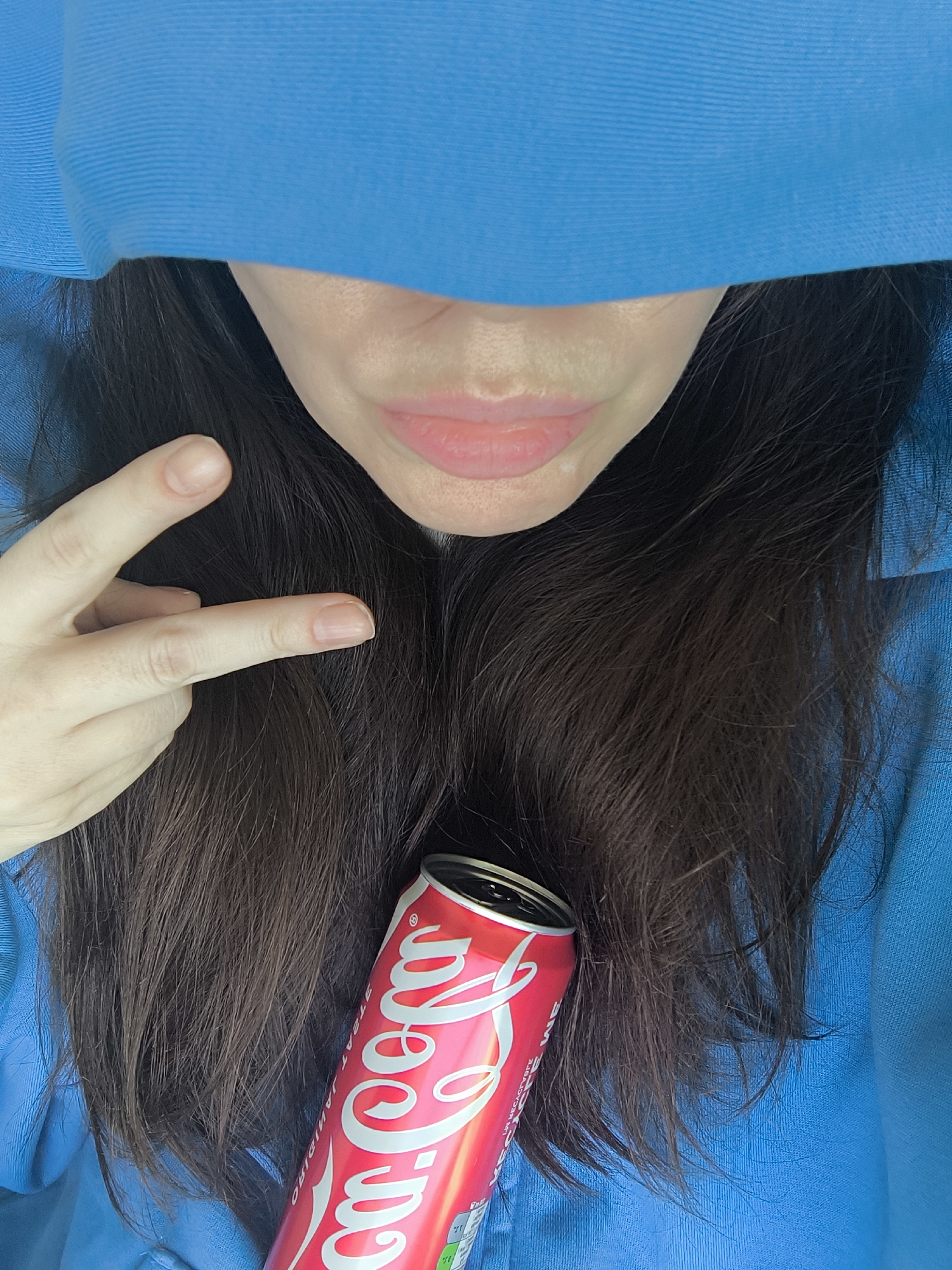 Person drinks Coke, accesses alcohol-free wine from fridge