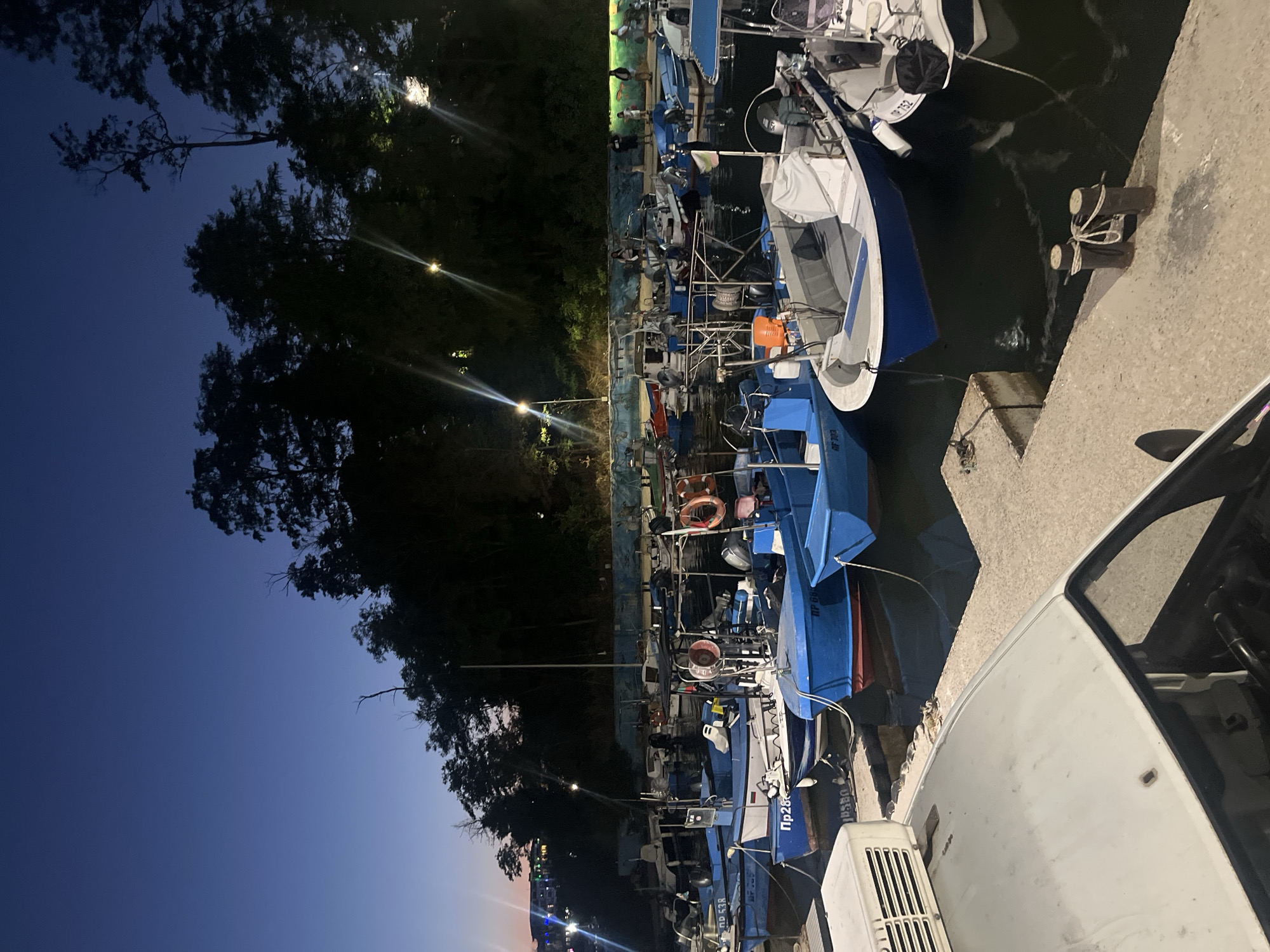 Primorsko harbor at dusk, boats moored under evening lights