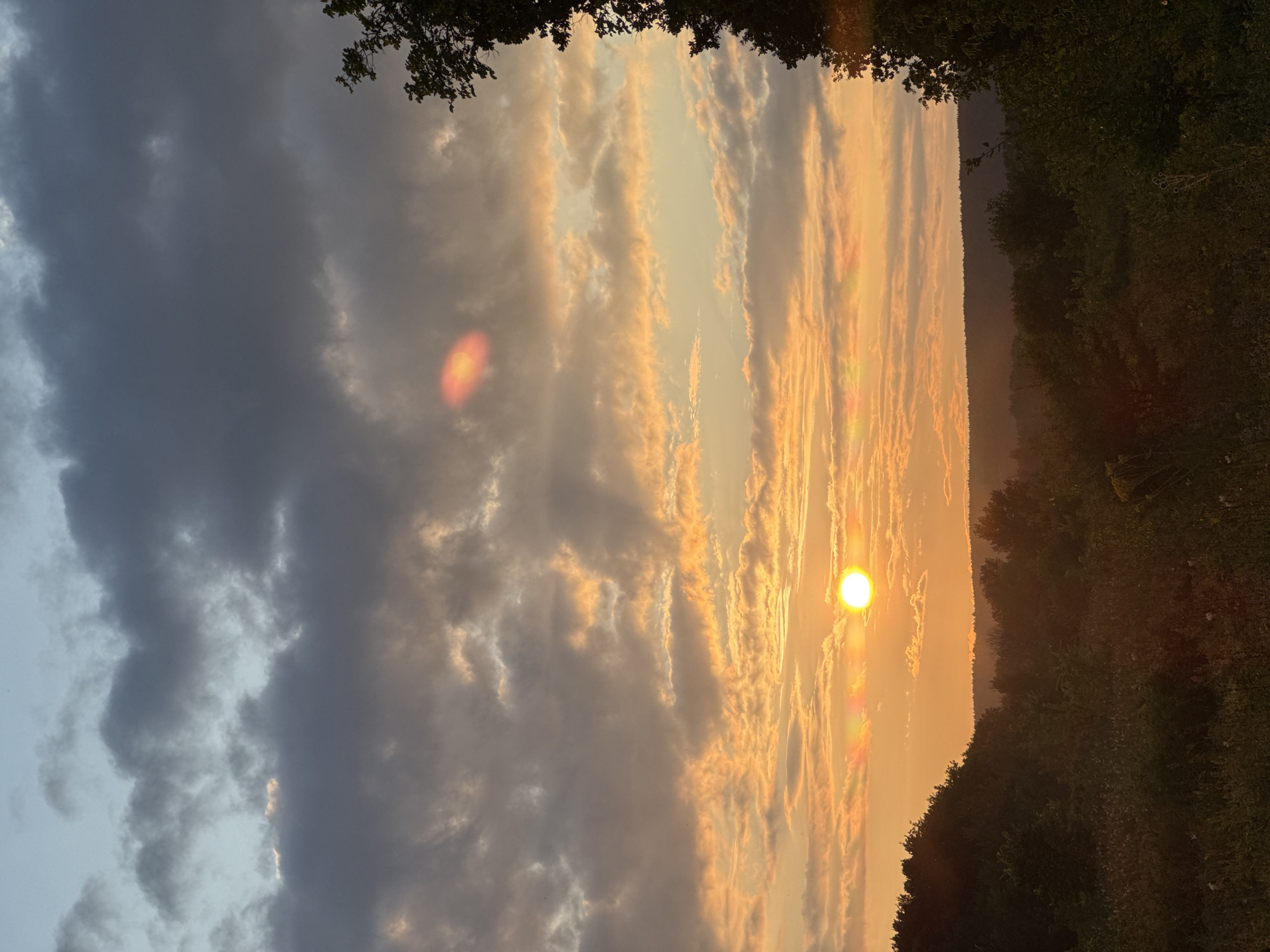 Wooden cabin at sunset, rolling hills and warm skies