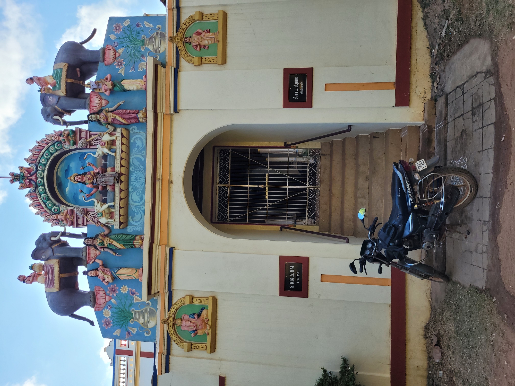 Ornate building with colorful sculptures documented under clear sky