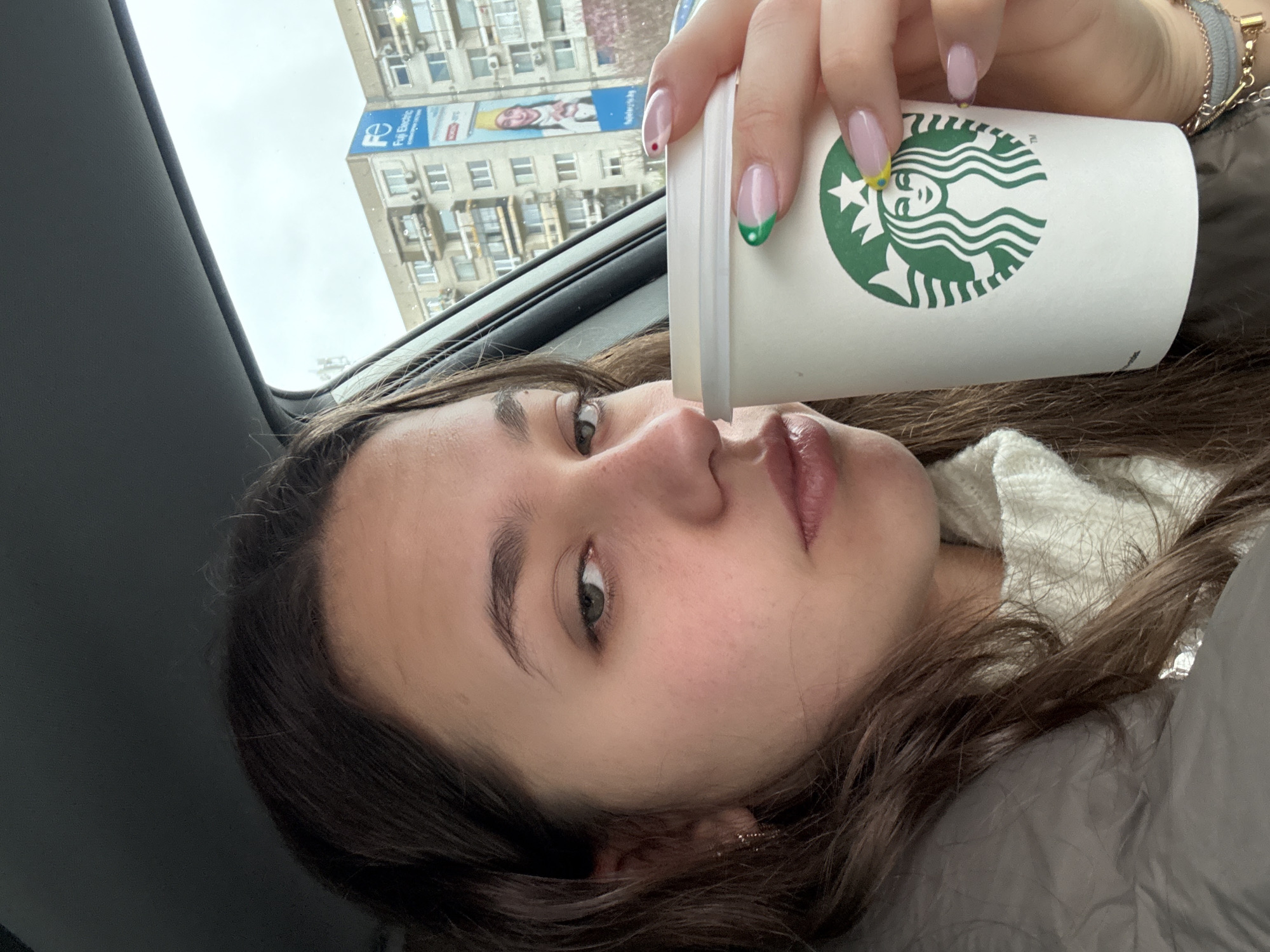 Woman takes morning selfies with coffee in Sofia