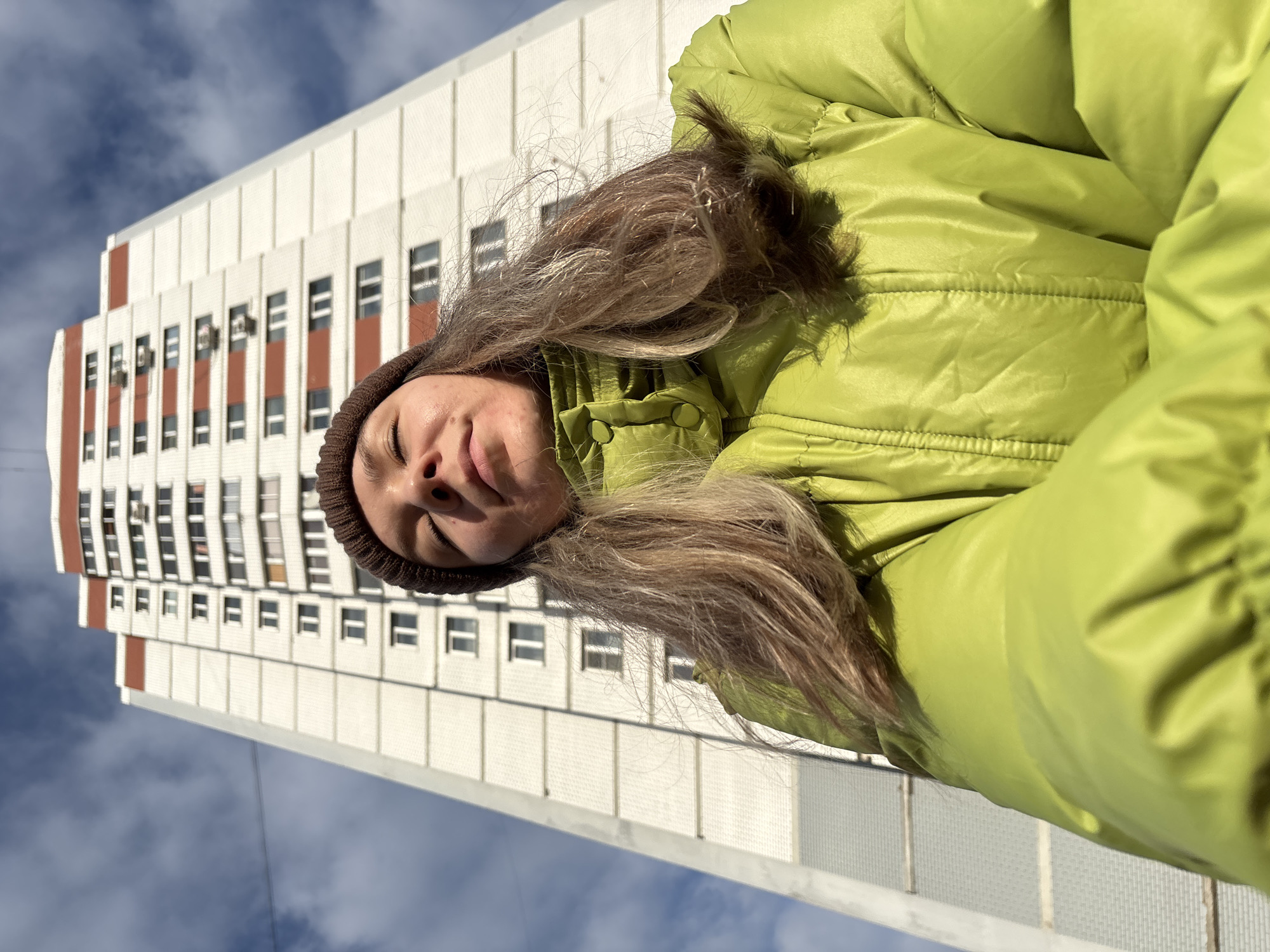 Woman photographed outside apartment building in Izhevsk, Russia