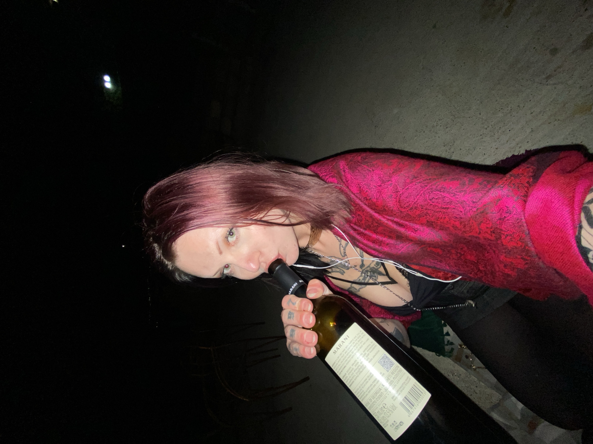 Woman drinks wine, smokes outdoors in Kunje, Montenegro