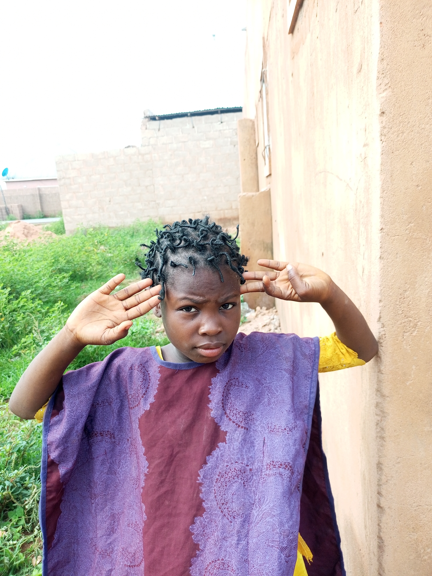 Daily life around a West African compound, morning routines underway