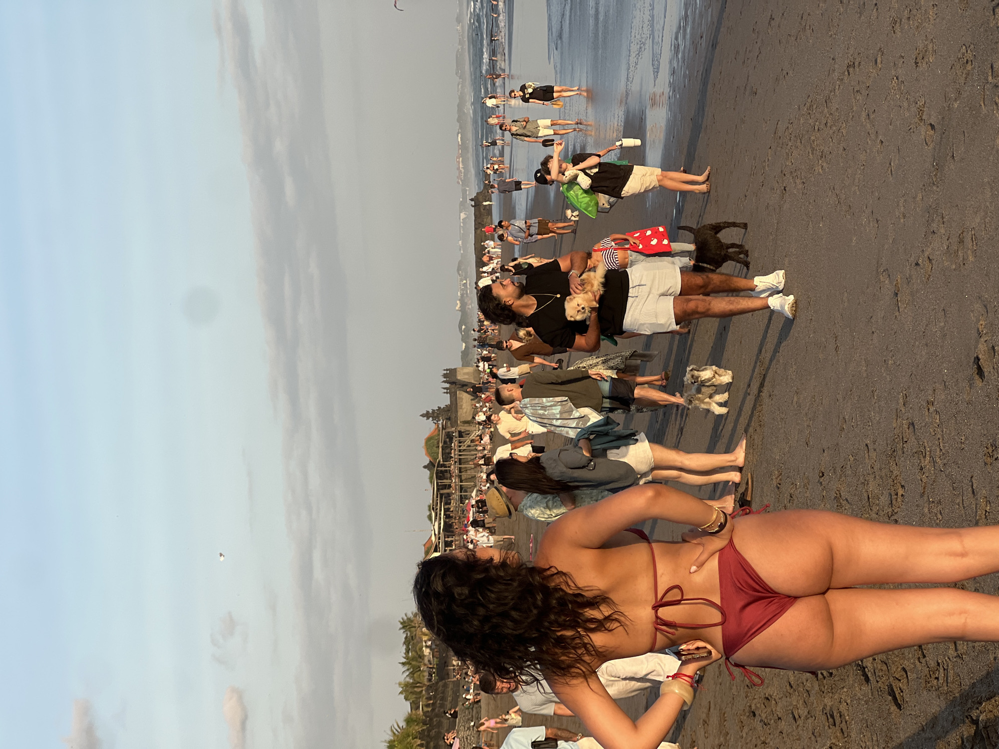 North Kuta beach at golden hour, crowds soaking up the sunset