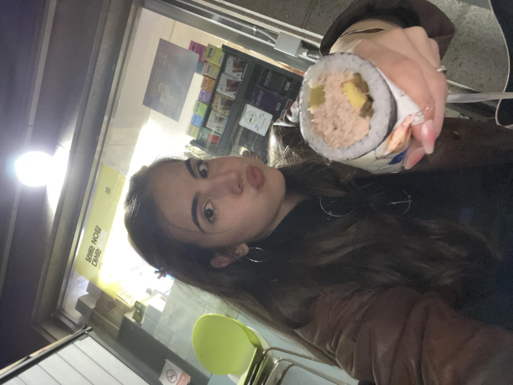 Woman holds tuna kimbap outside Seoul convenience store